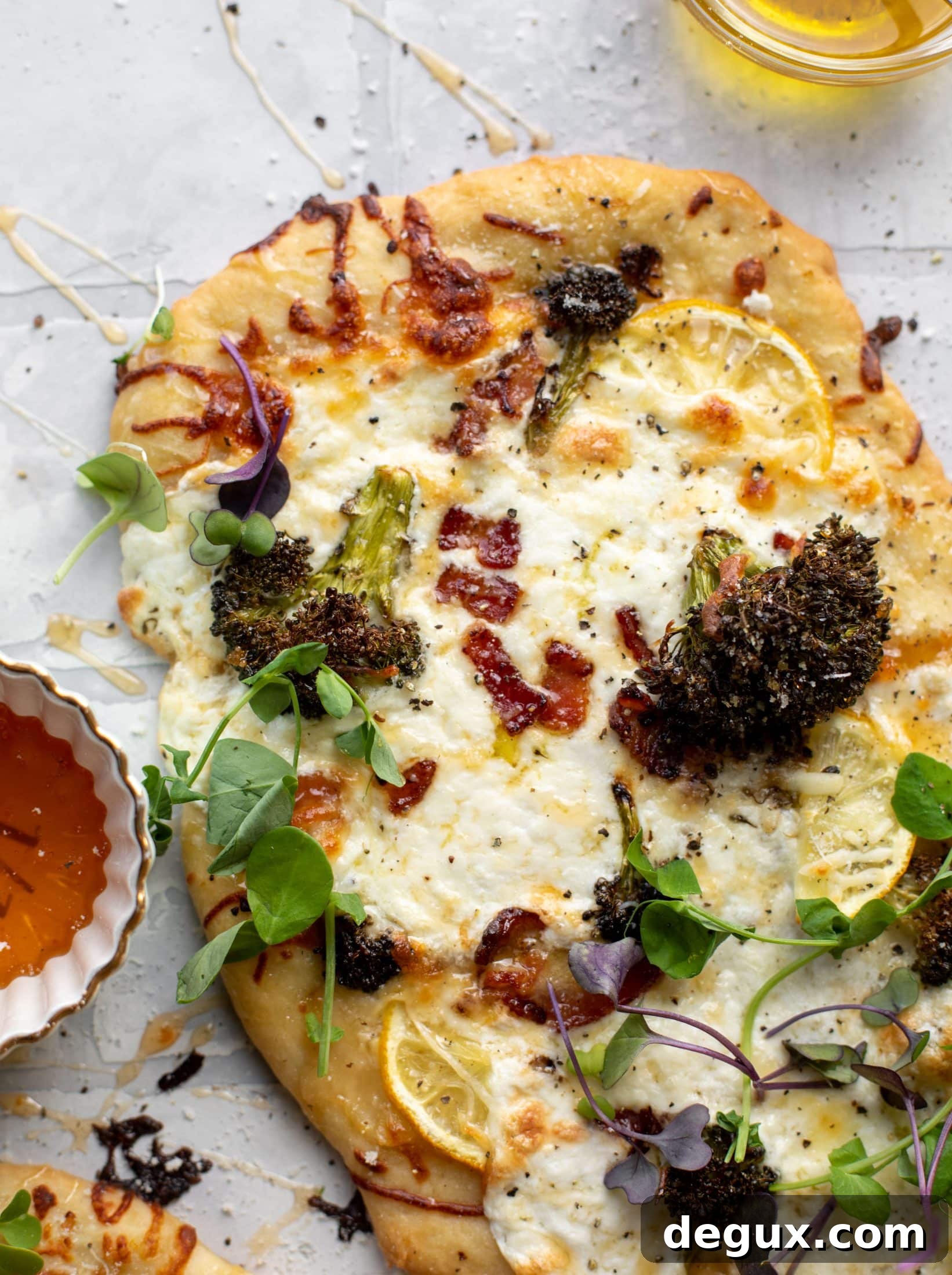 Cheesy Lemon Flatbread Pizza Drizzled with Spicy Honey 6 This cheesy lemon flatbread pizza is covered with burrata cheese, parmesan, roasted vegetables and hot honey. It's a flavor dream!