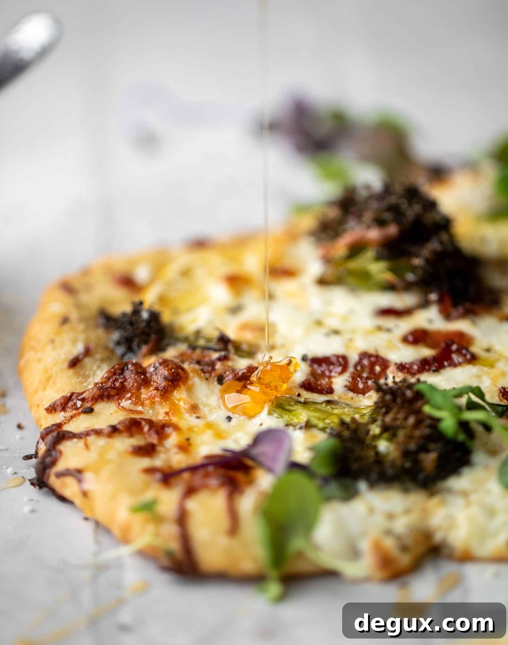 Cheesy Lemon Flatbread Pizza Drizzled with Spicy Honey 7 This cheesy lemon flatbread pizza is covered with burrata cheese, parmesan, roasted vegetables and hot honey. It's a flavor dream!
