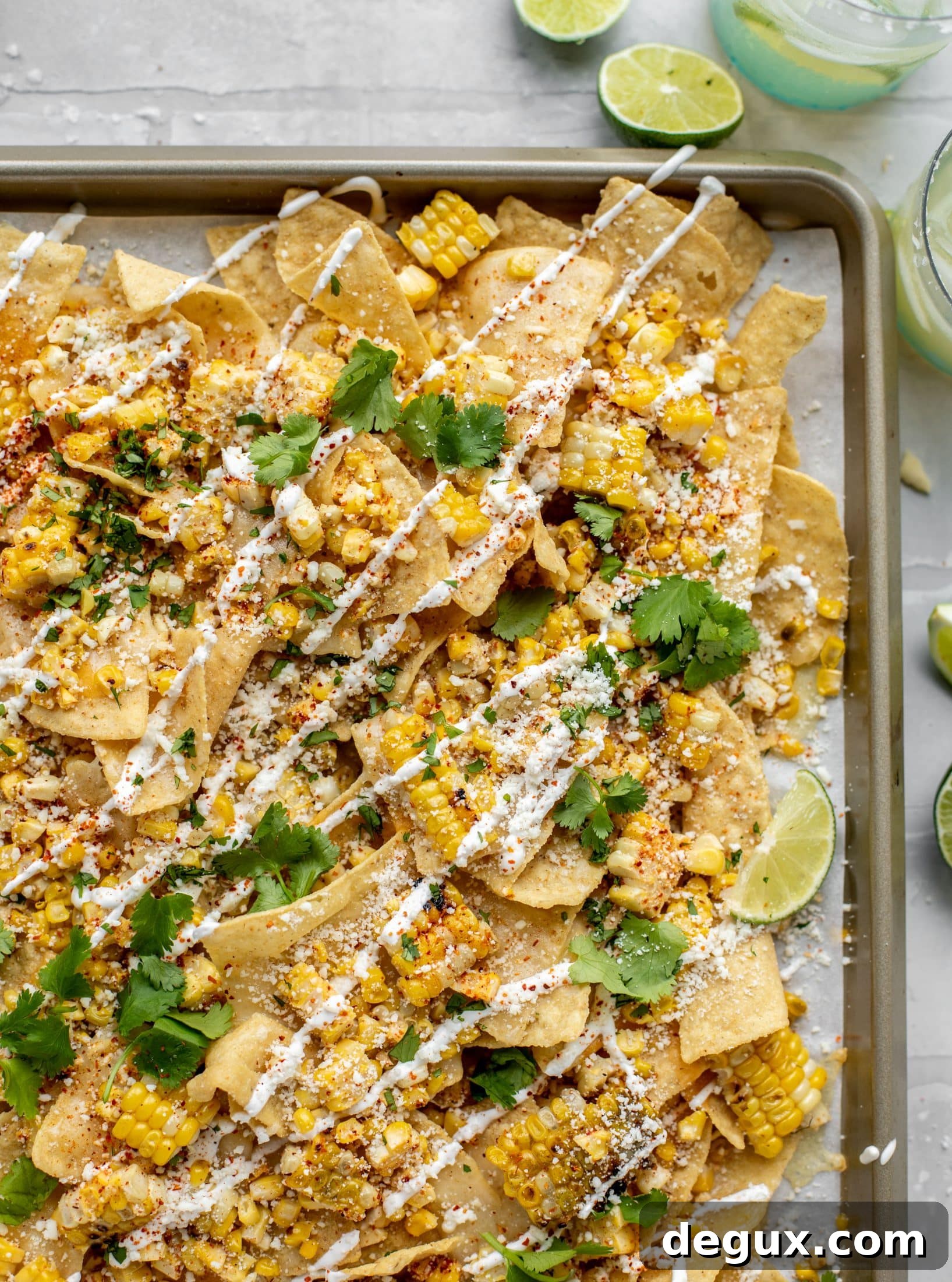 Sheet Pan Street Corn Nachos Recipe for Crowd-Friendly Snack 7 These sheet pan street corn nachos are ridiculously easy and delicious! Grilled corn, chili, lime, tons of cheese and all the flavor you could dream of!