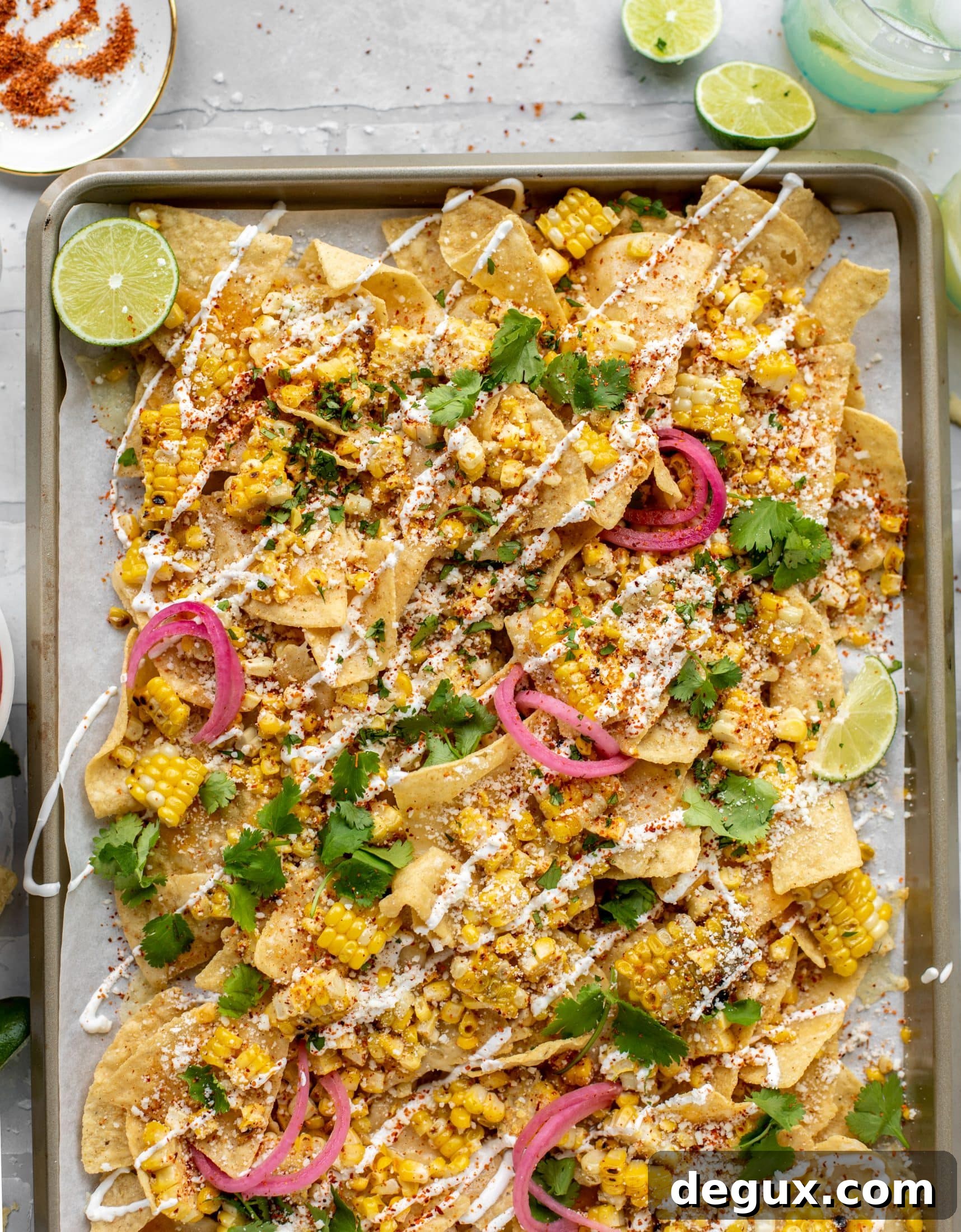 Sheet Pan Street Corn Nachos Recipe for Crowd-Friendly Snack 8 These sheet pan street corn nachos are ridiculously easy and delicious! Grilled corn, chili, lime, tons of cheese and all the flavor you could dream of!