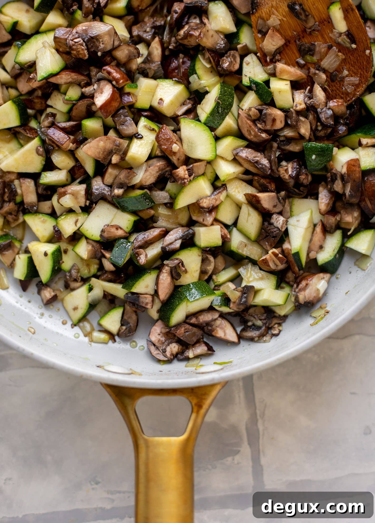zucchini, mushrooms and onions in a skillet