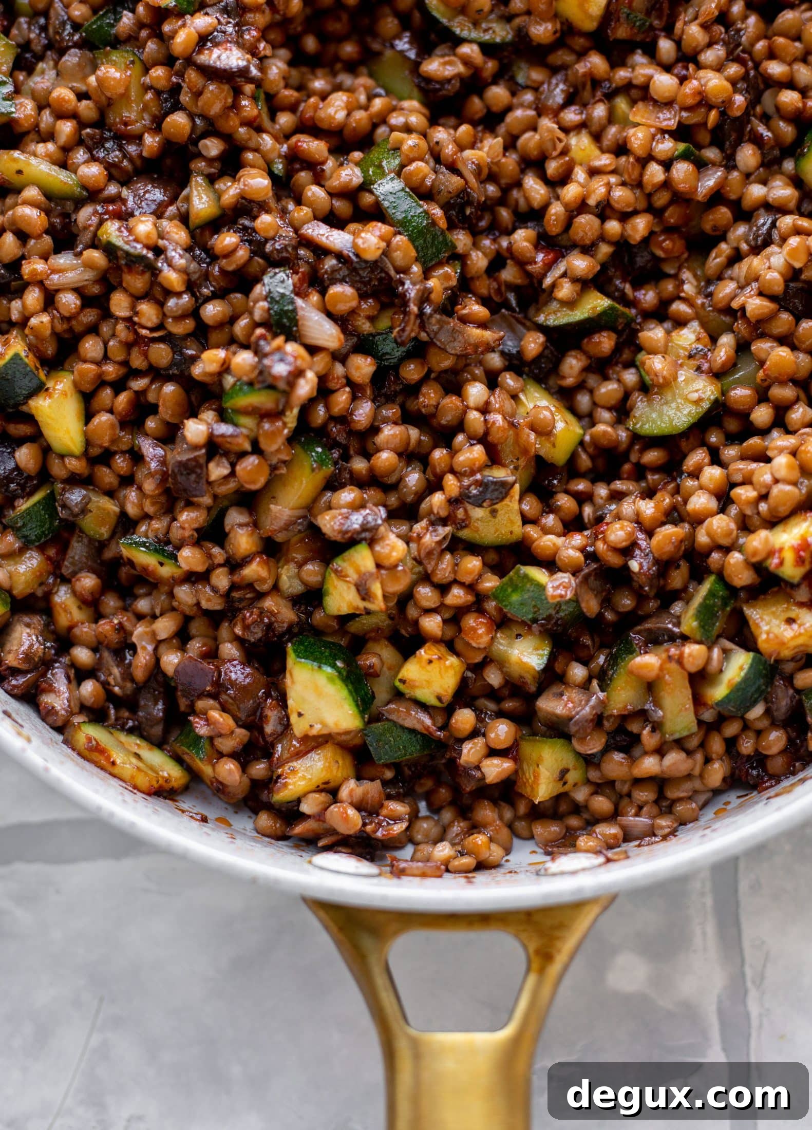 lentils with zucchini and mushrooms in a skillet