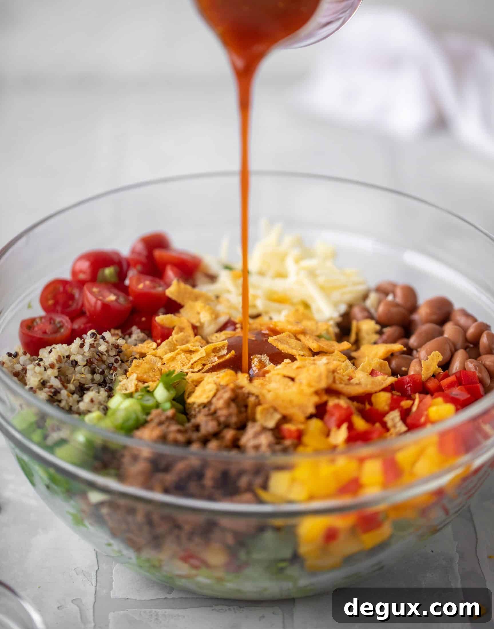 pouring catalina dressing onto taco salad