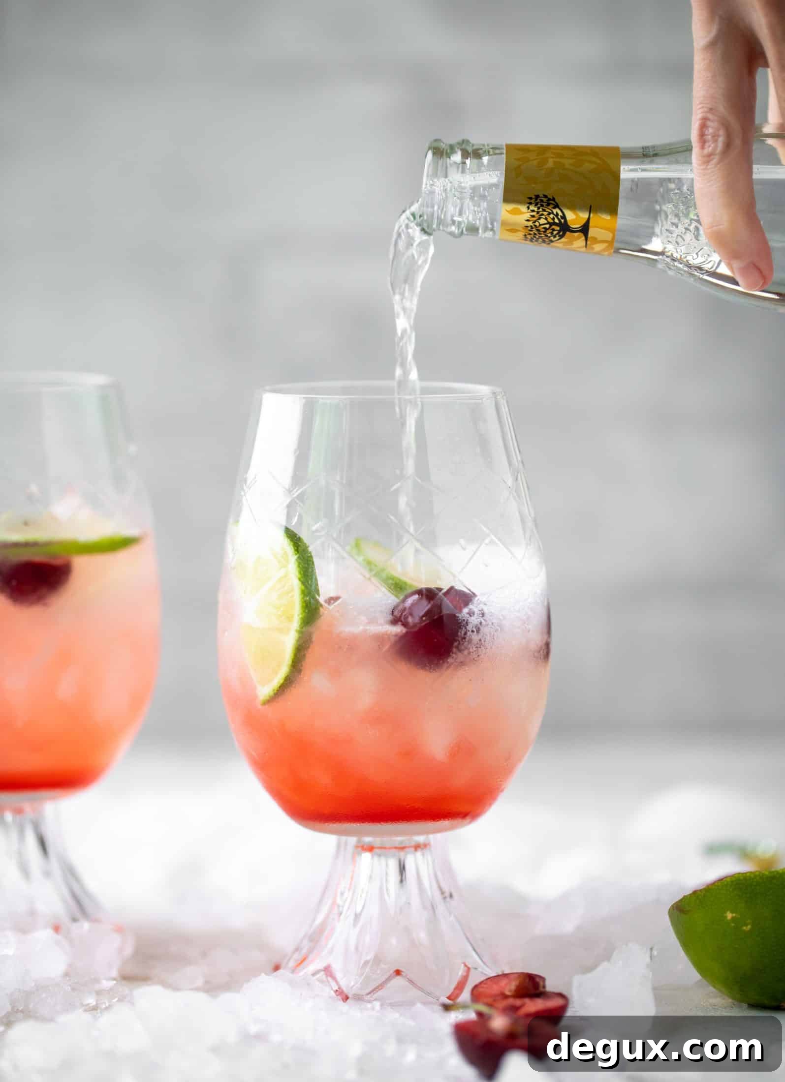 Cherry Lime Gin & Tonic Cocktail Recipe: Refreshing Summer Drink 4 pouring tonic water into cherry gin and tonic