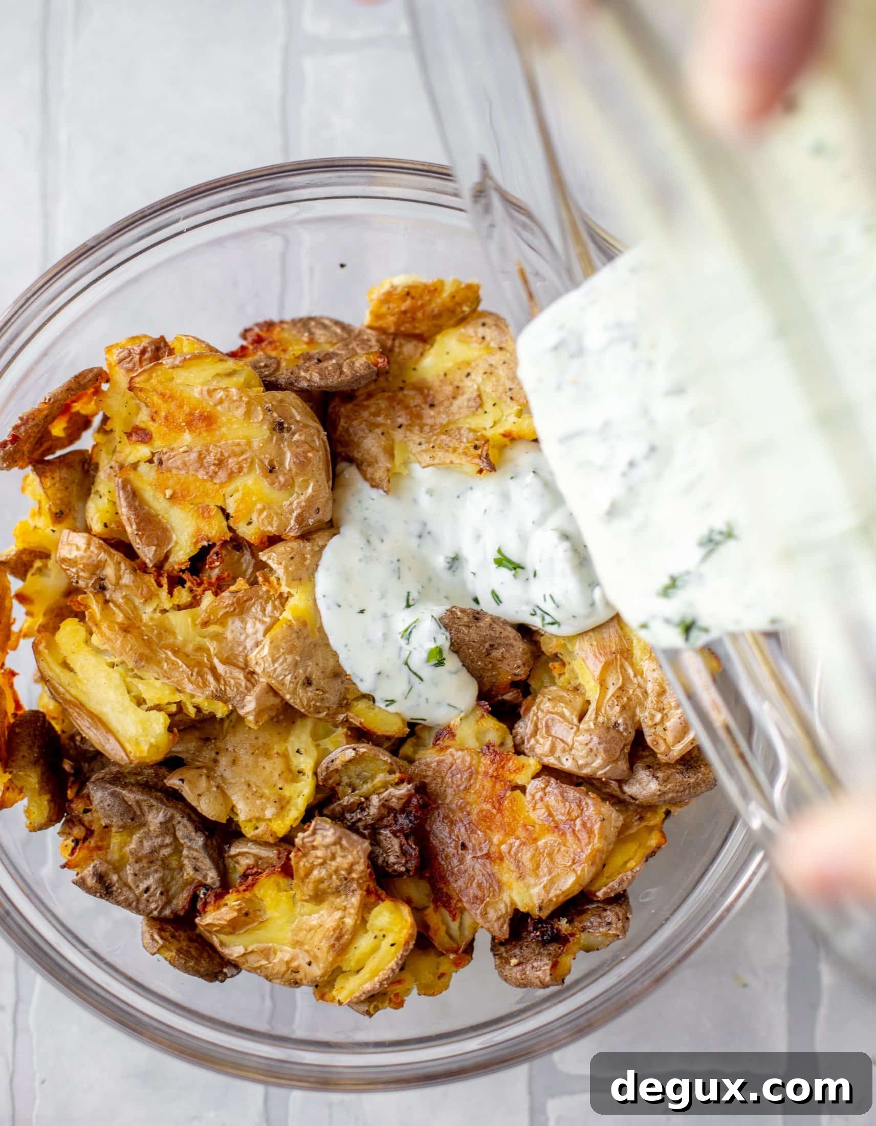 pouring dressed on smashed potatoes