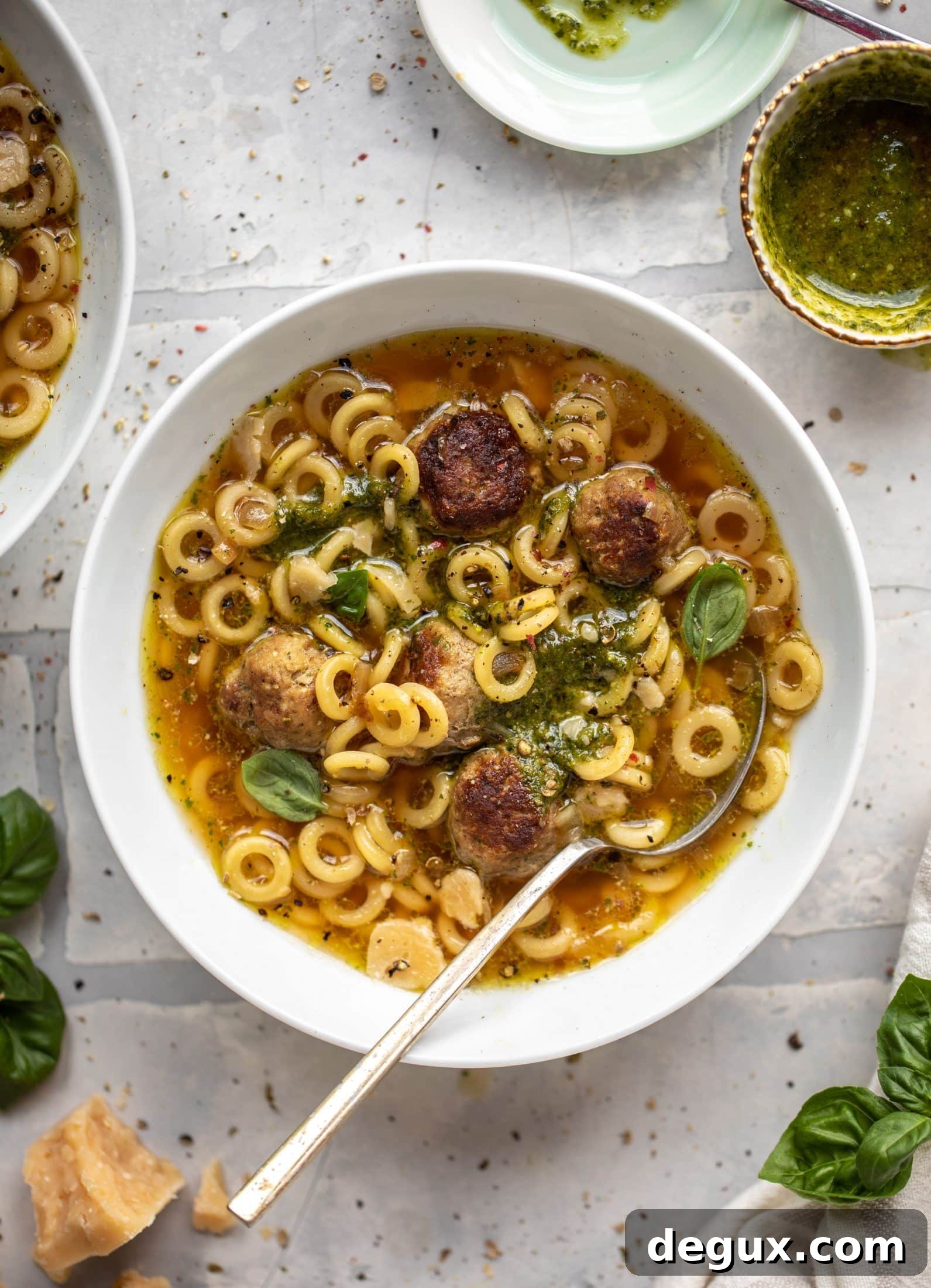 summer pesto mini meatball soup with spoon