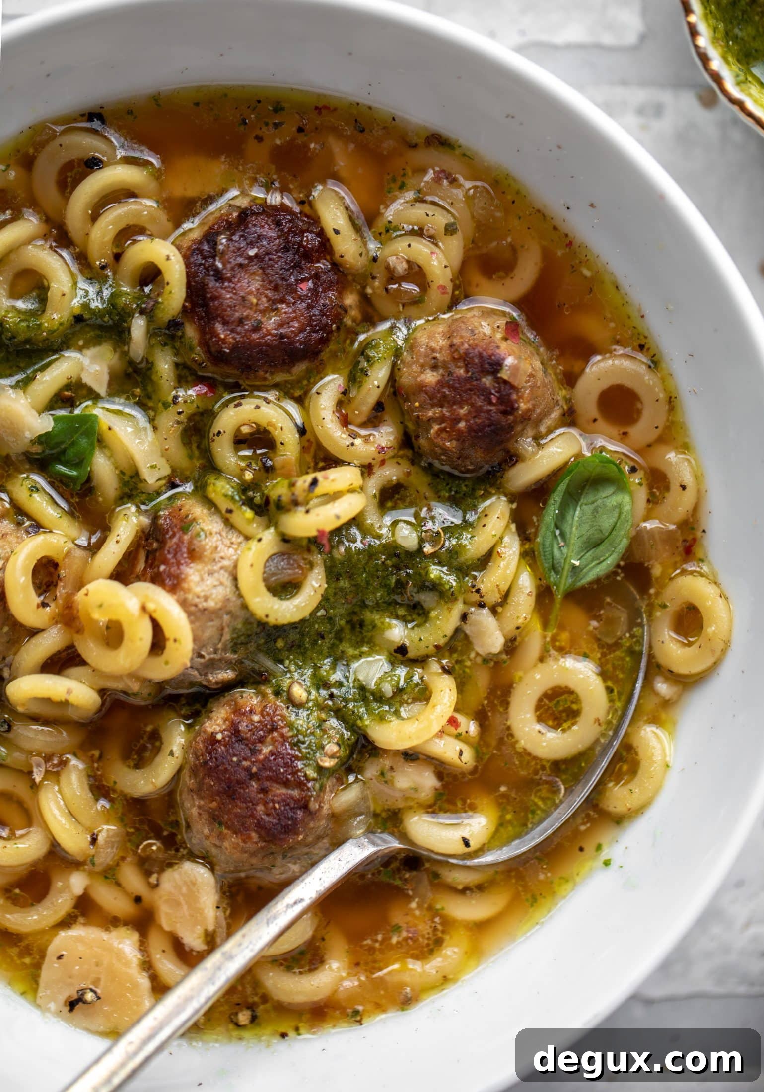 summer pesto mini meatball soup with spoon