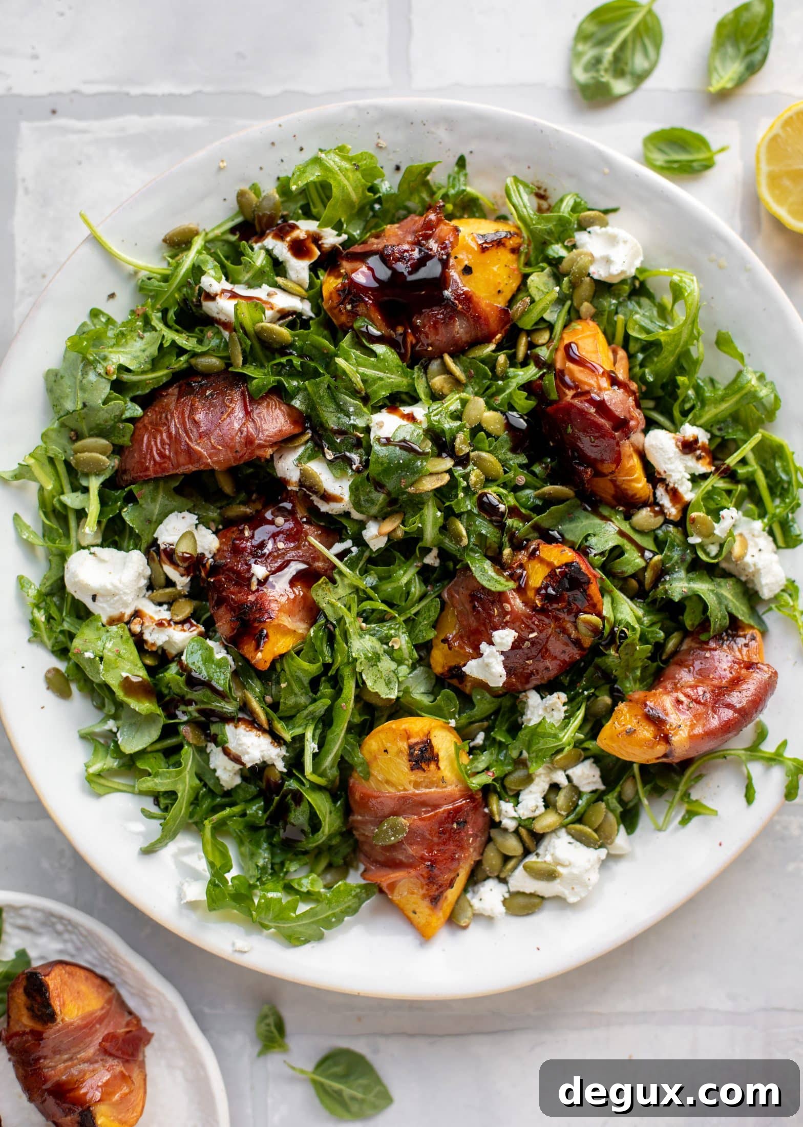 Grilled Prosciutto-Wrapped Peaches with Arugula and Goat Cheese 2 grilled prosciutto wrapped peaches with arugula and goat cheese