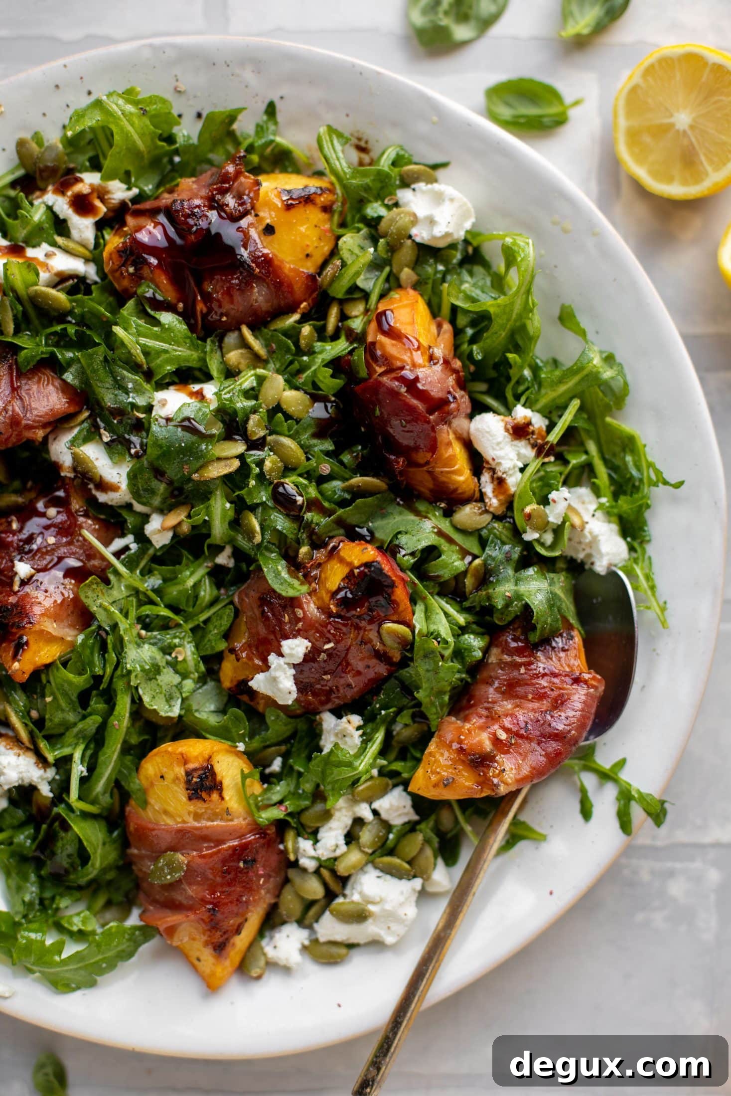 Grilled Prosciutto-Wrapped Peaches with Arugula and Goat Cheese 8 grilled prosciutto wrapped peaches with arugula and goat cheese