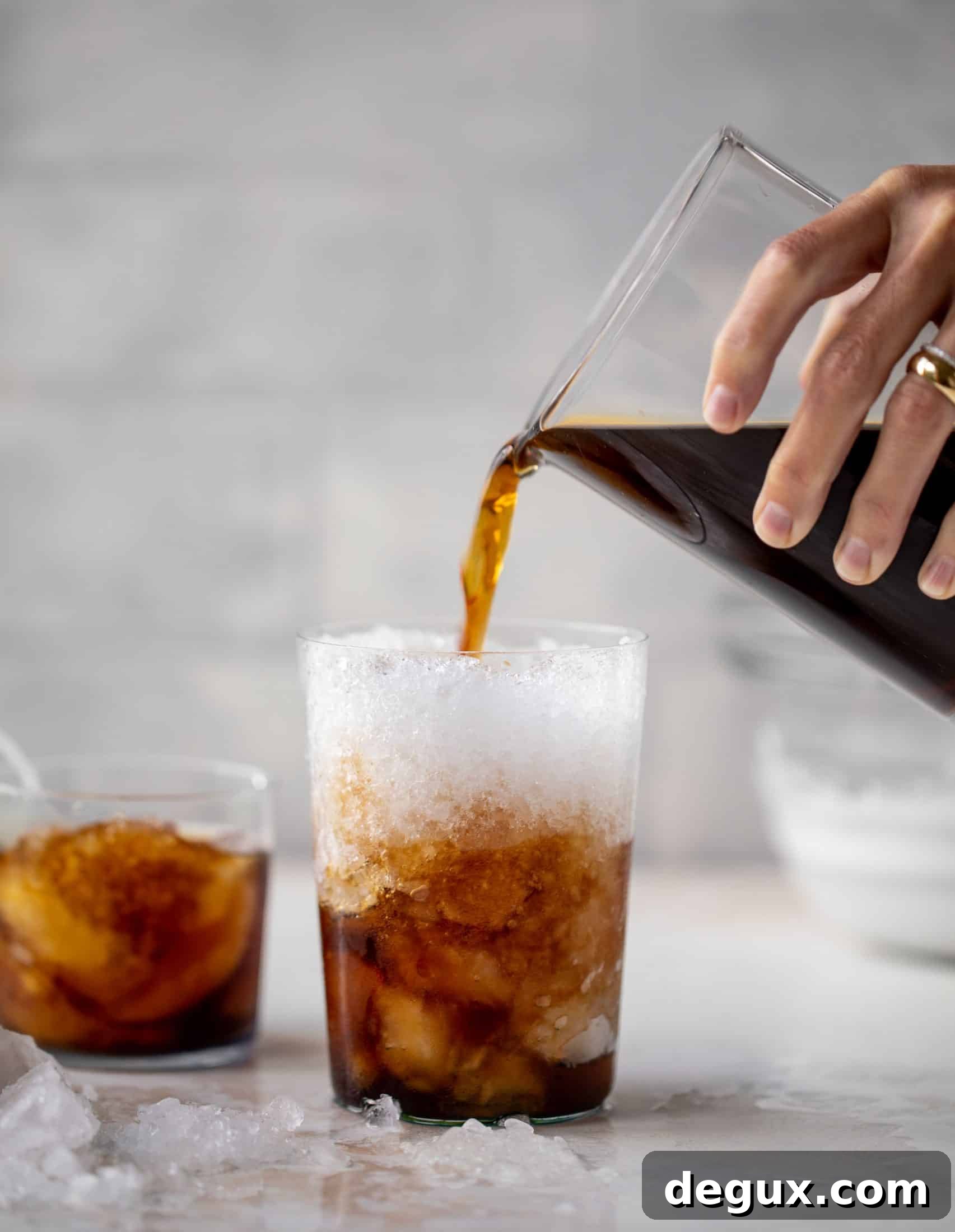 Whipped Coconut Cream Cold Brew Recipe for Creamy Iced Coffee 3 pouring cold brew over ice