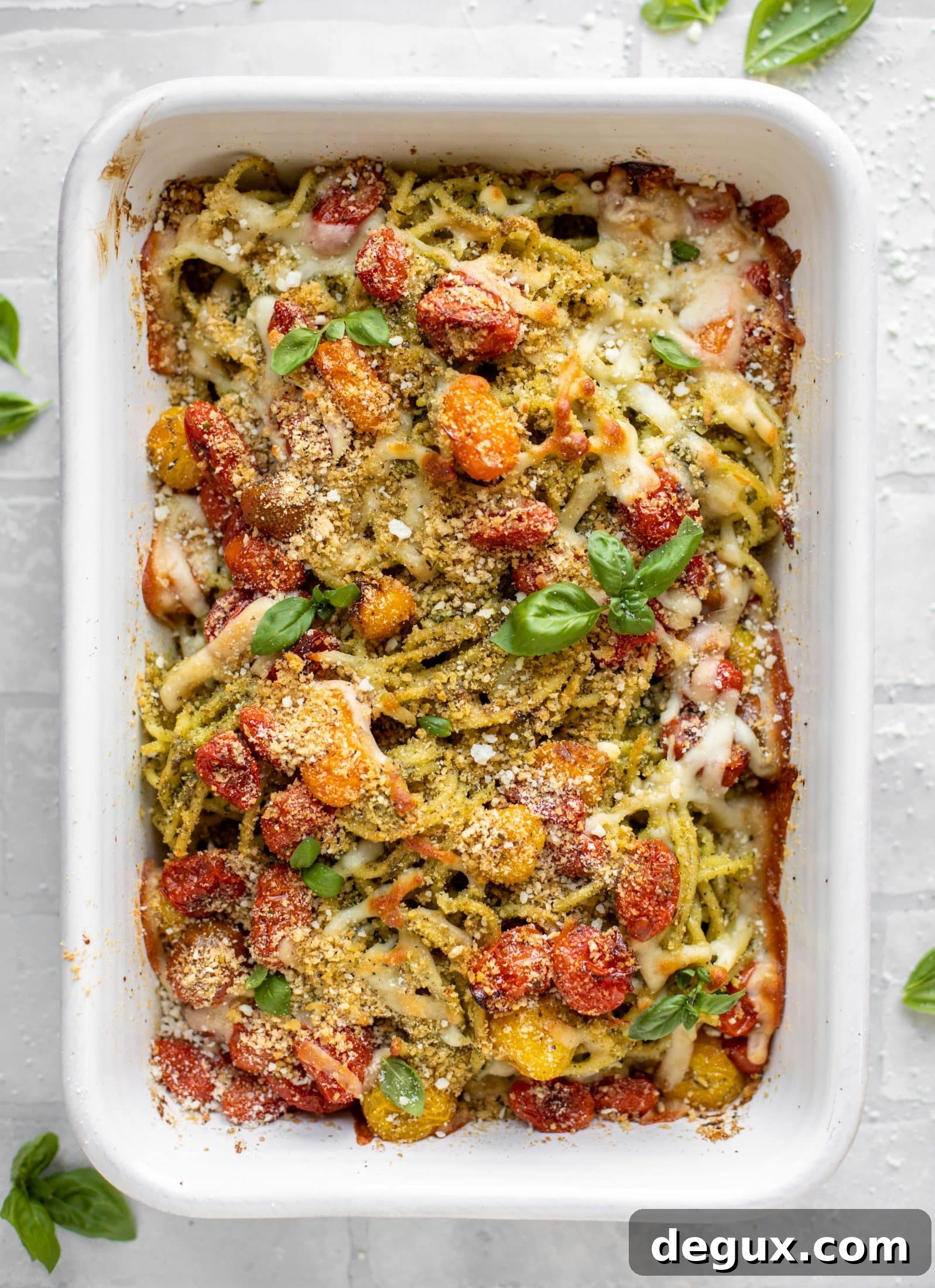 baked pesto bucatini with burst tomatoes
