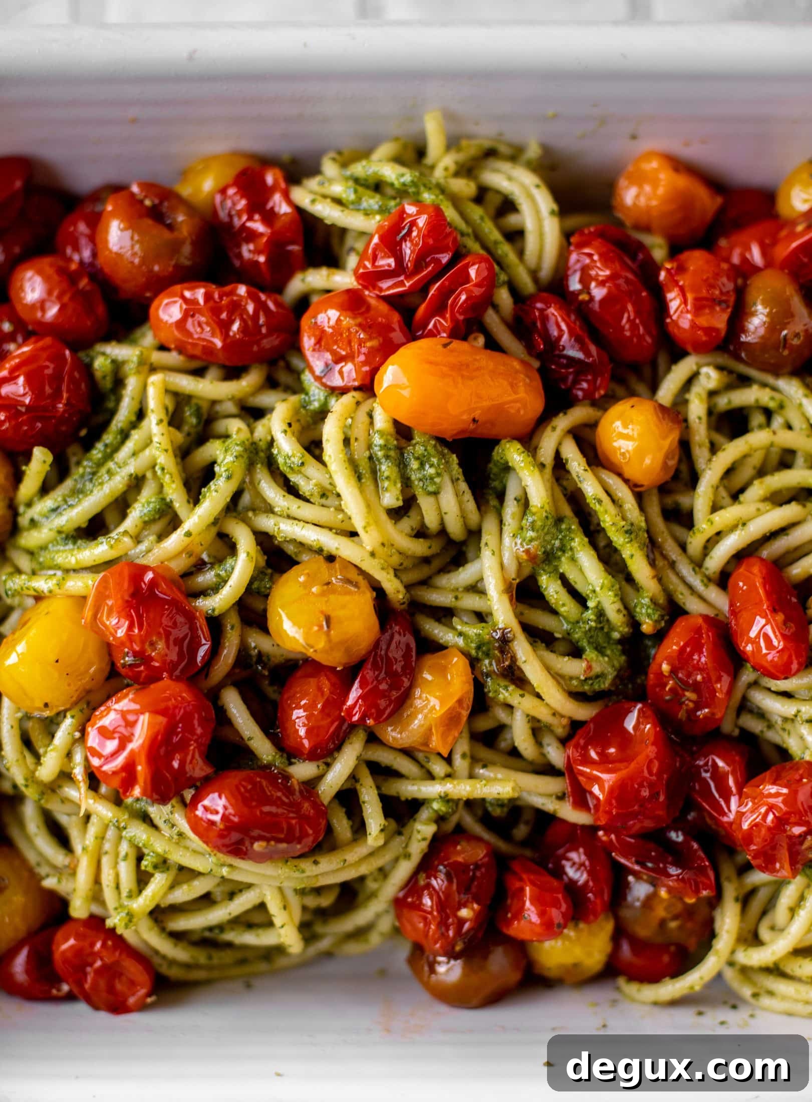 baked pesto bucatini with burst tomatoes