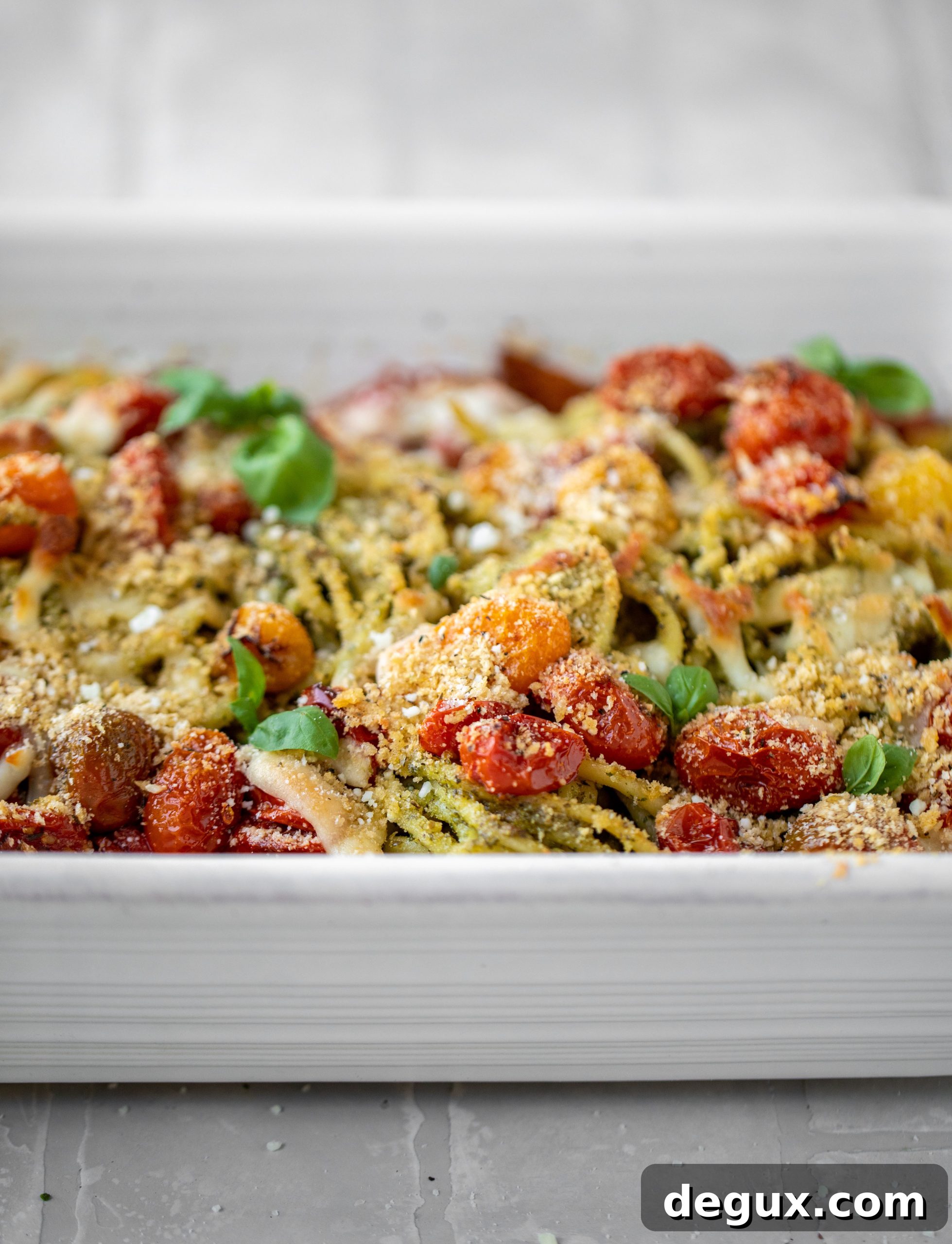 baked pesto bucatini with burst tomatoes