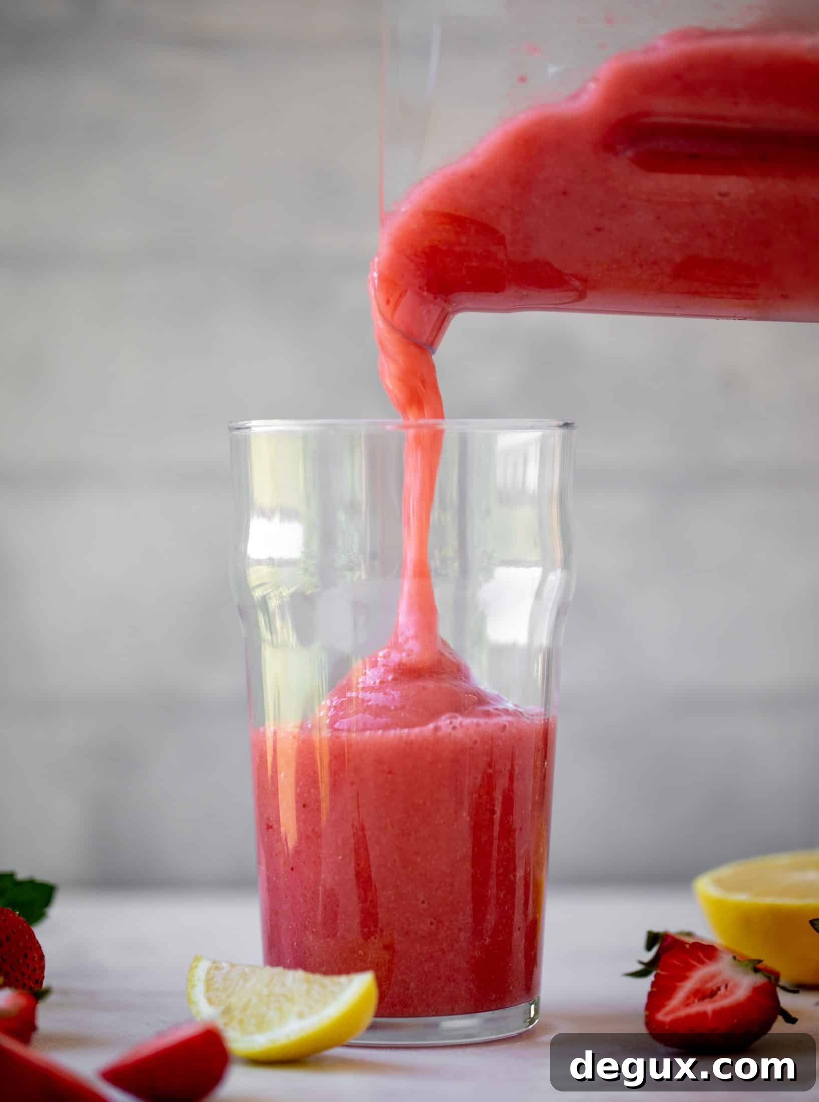 pouring frozen strawberry lemonade