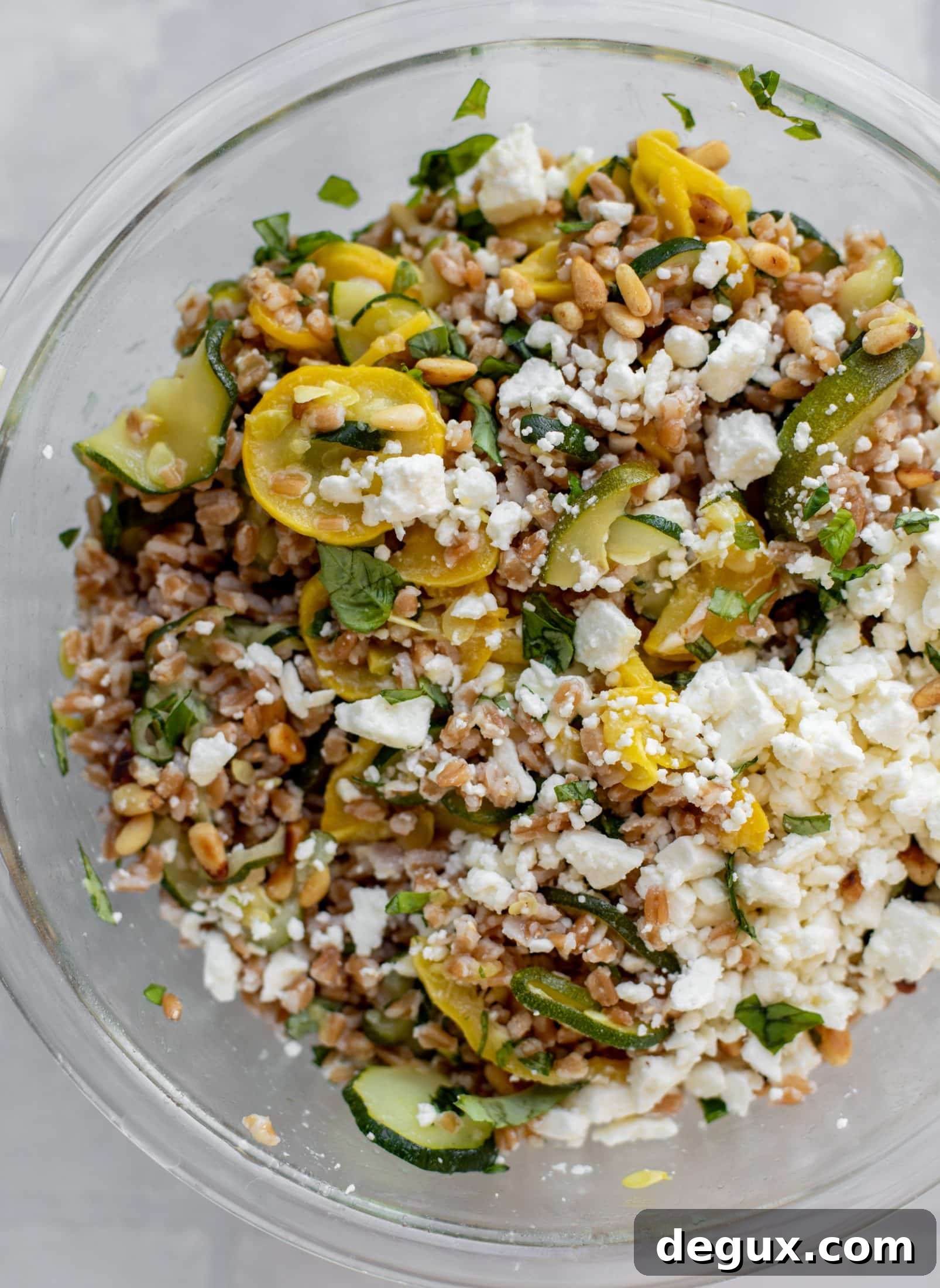 tossing summer squash basil farro salad