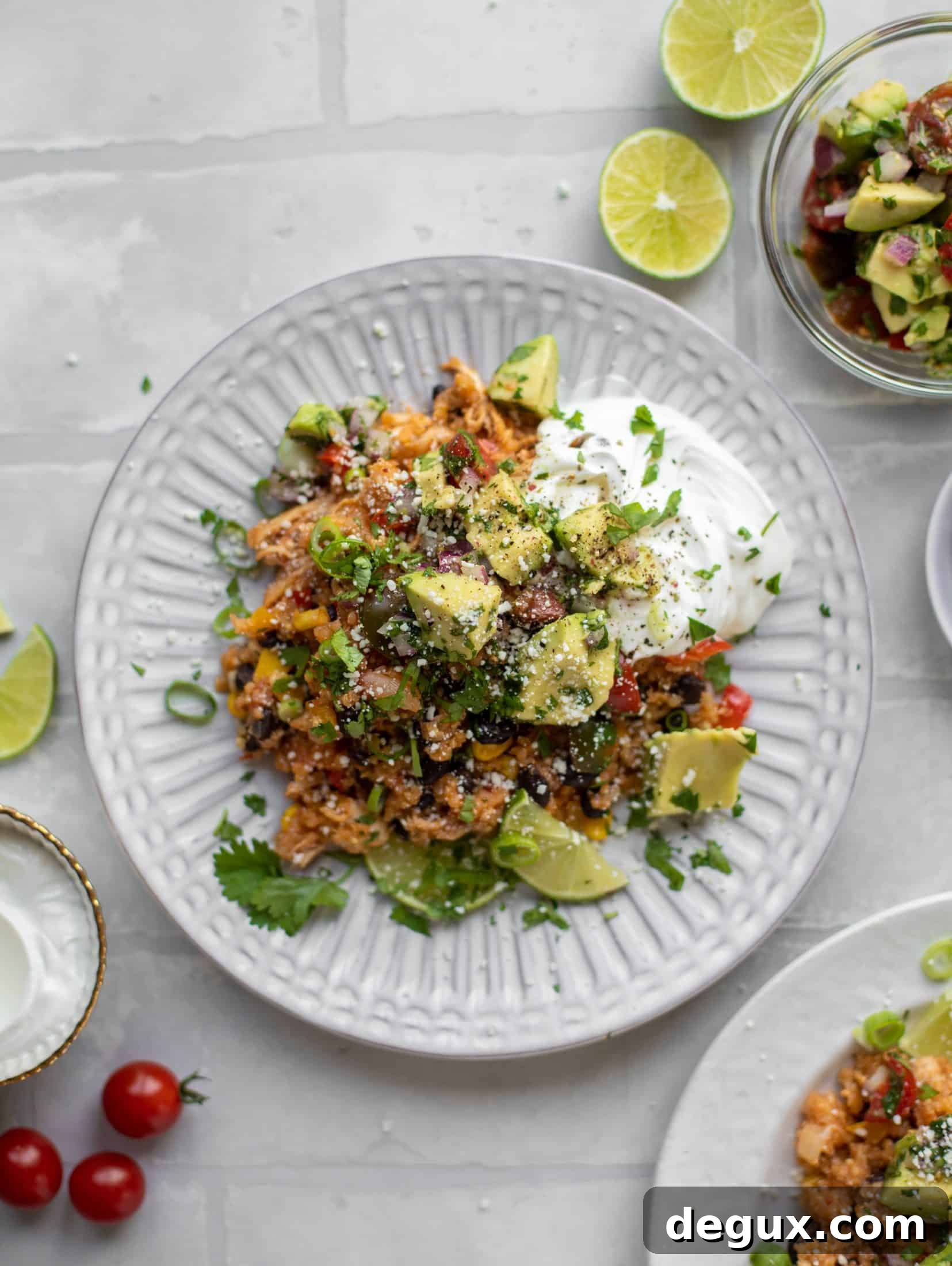 one pot salsa chicken quinoa topped with avocado pico de gallo and sour cream