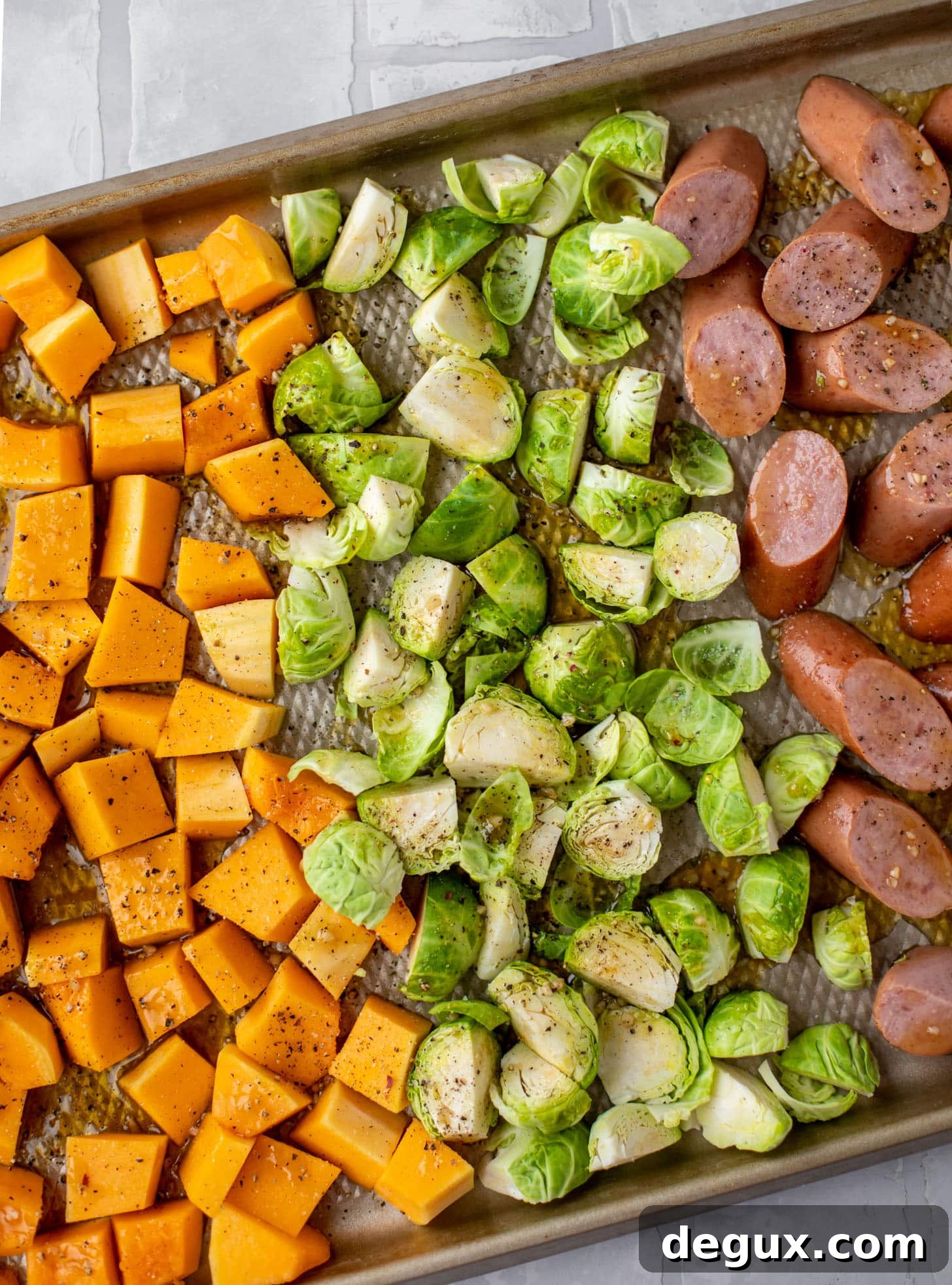 squash, brussels and sausage on the sheet pan
