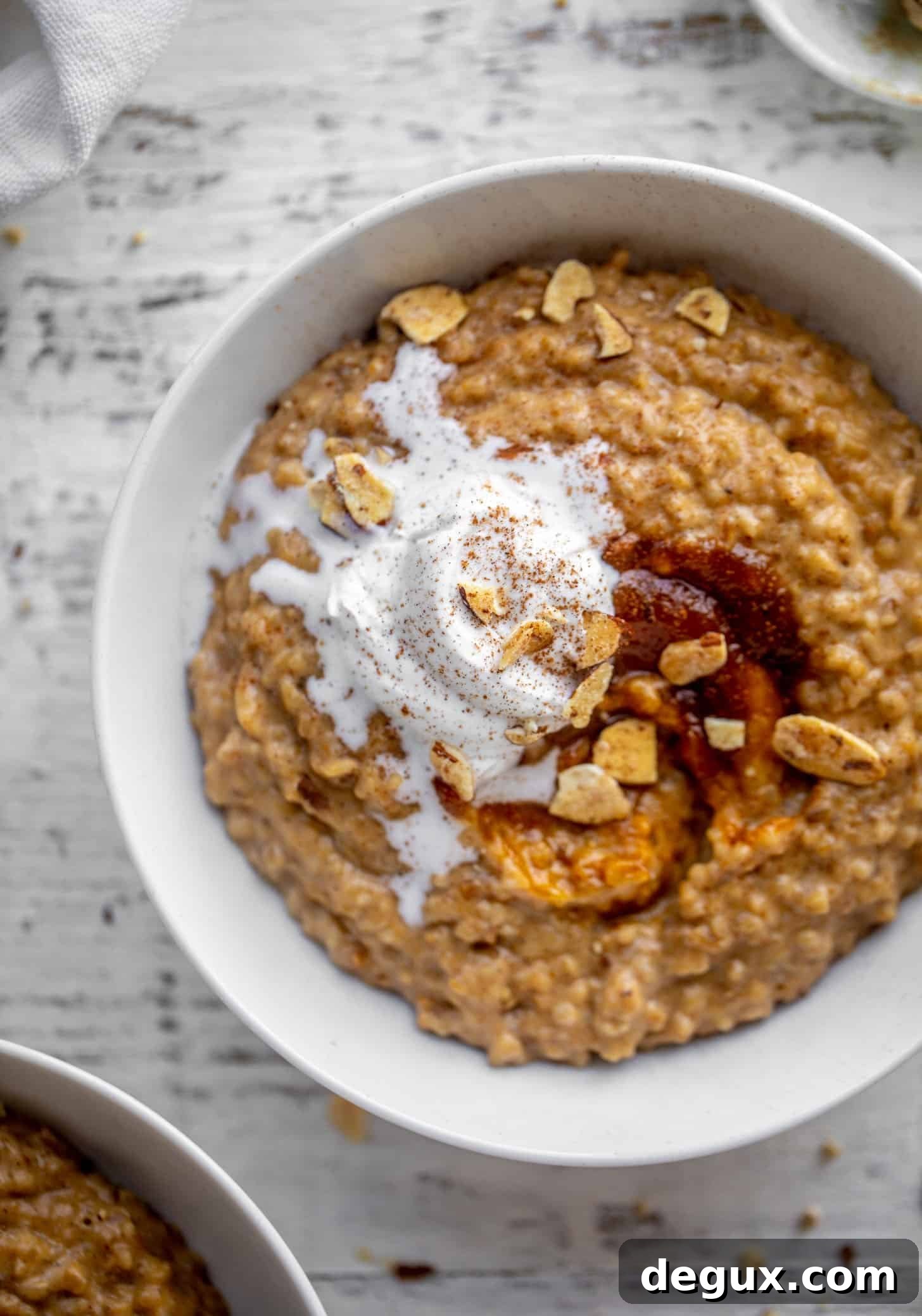 pumpkin pie oatmeal with coconut cream and almonds