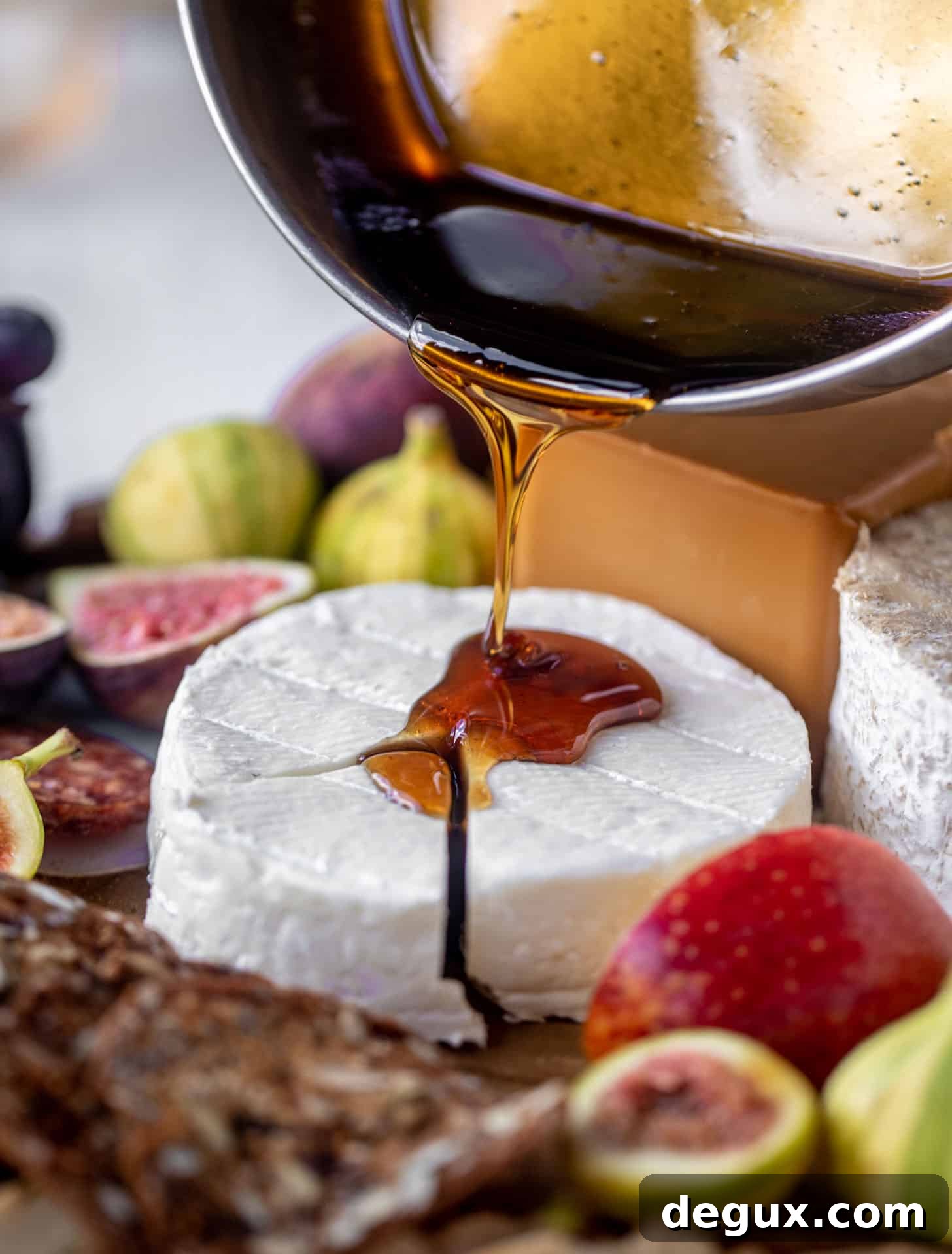 Autumn Cheese Board Featuring Bourbon Crackling Caramel 3 pouring bourbon crackling caramel on cheese