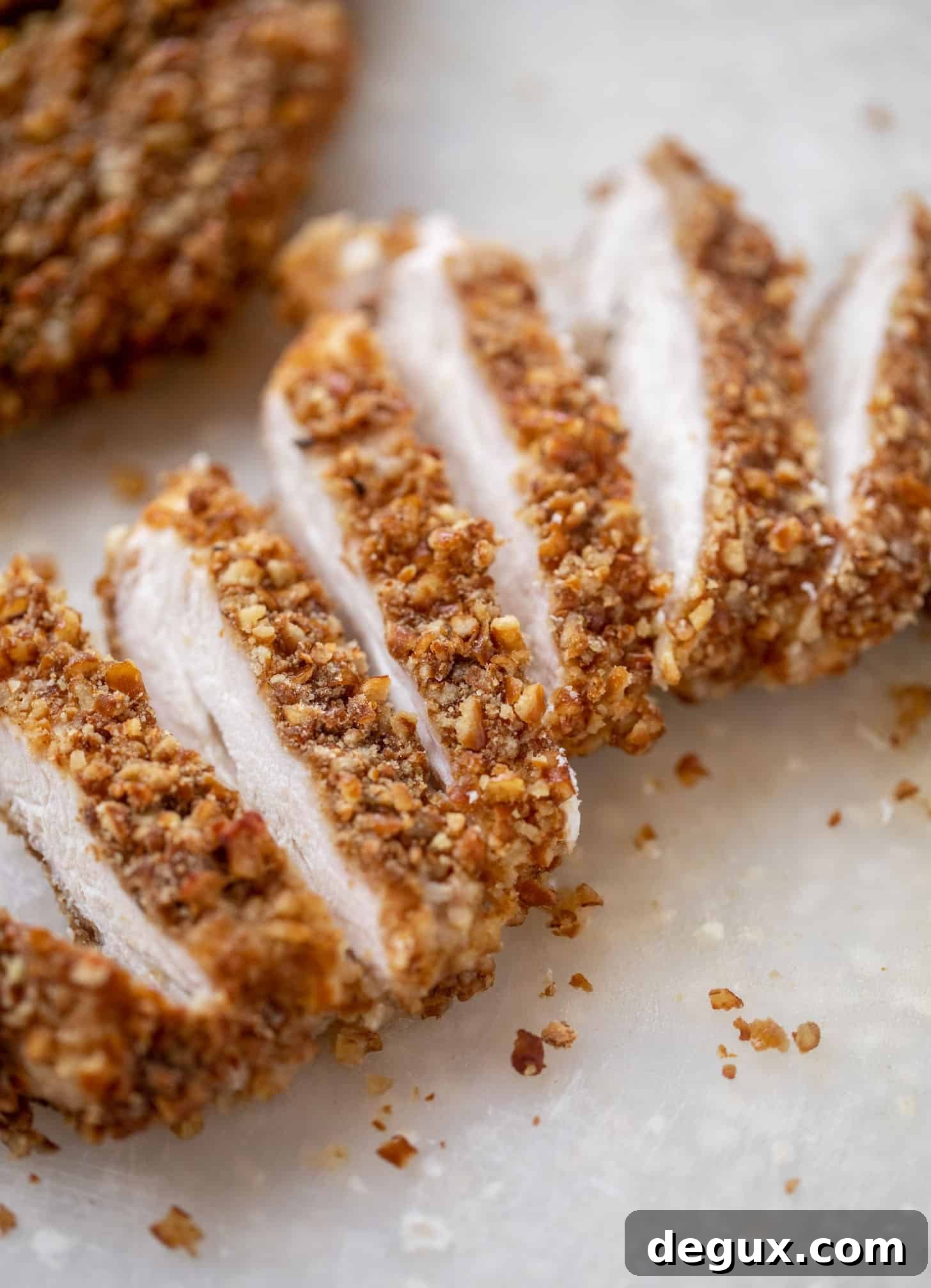 Crunchy Pretzel-Crusted Chicken Salad with Tangy Mustard Vinaigrette 4 sliced pretzel crusted chicken on cutting board