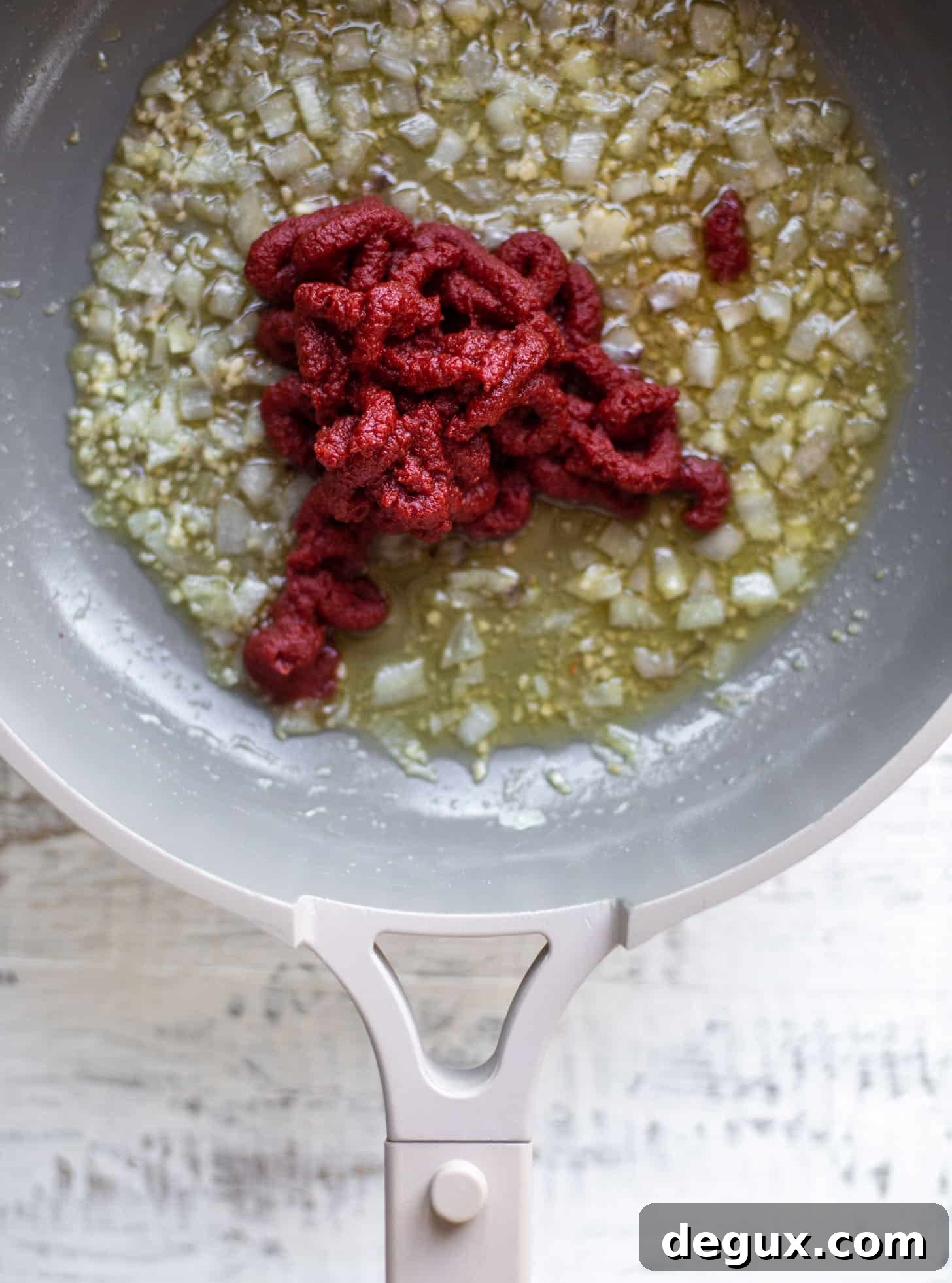 tomato paste with sautéed onions and garlic