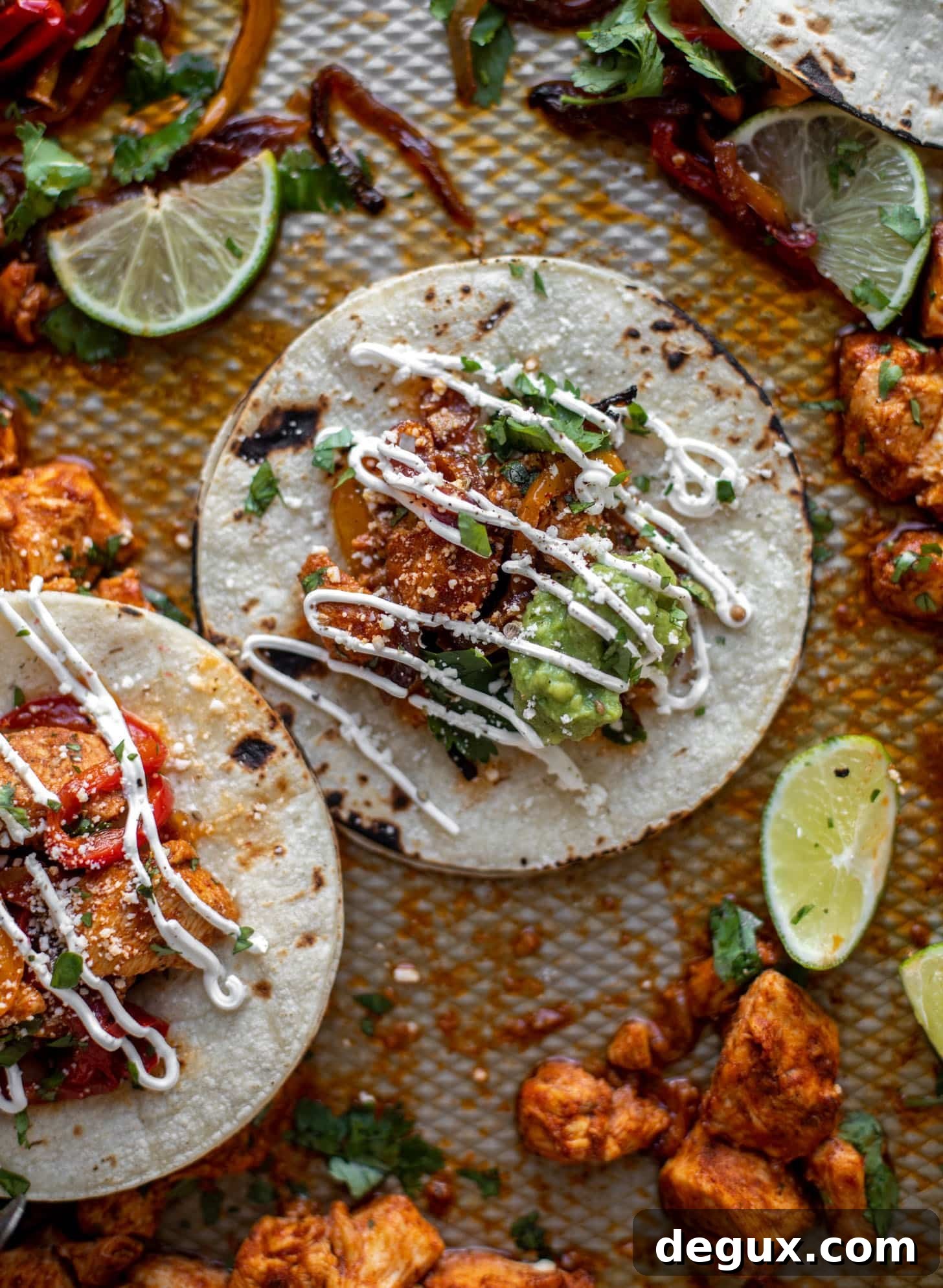 Lime Sheet-Pan Chicken Fajitas with Quick Guacamole 3 sheet pan chicken fajitas on tortillas with sour cream