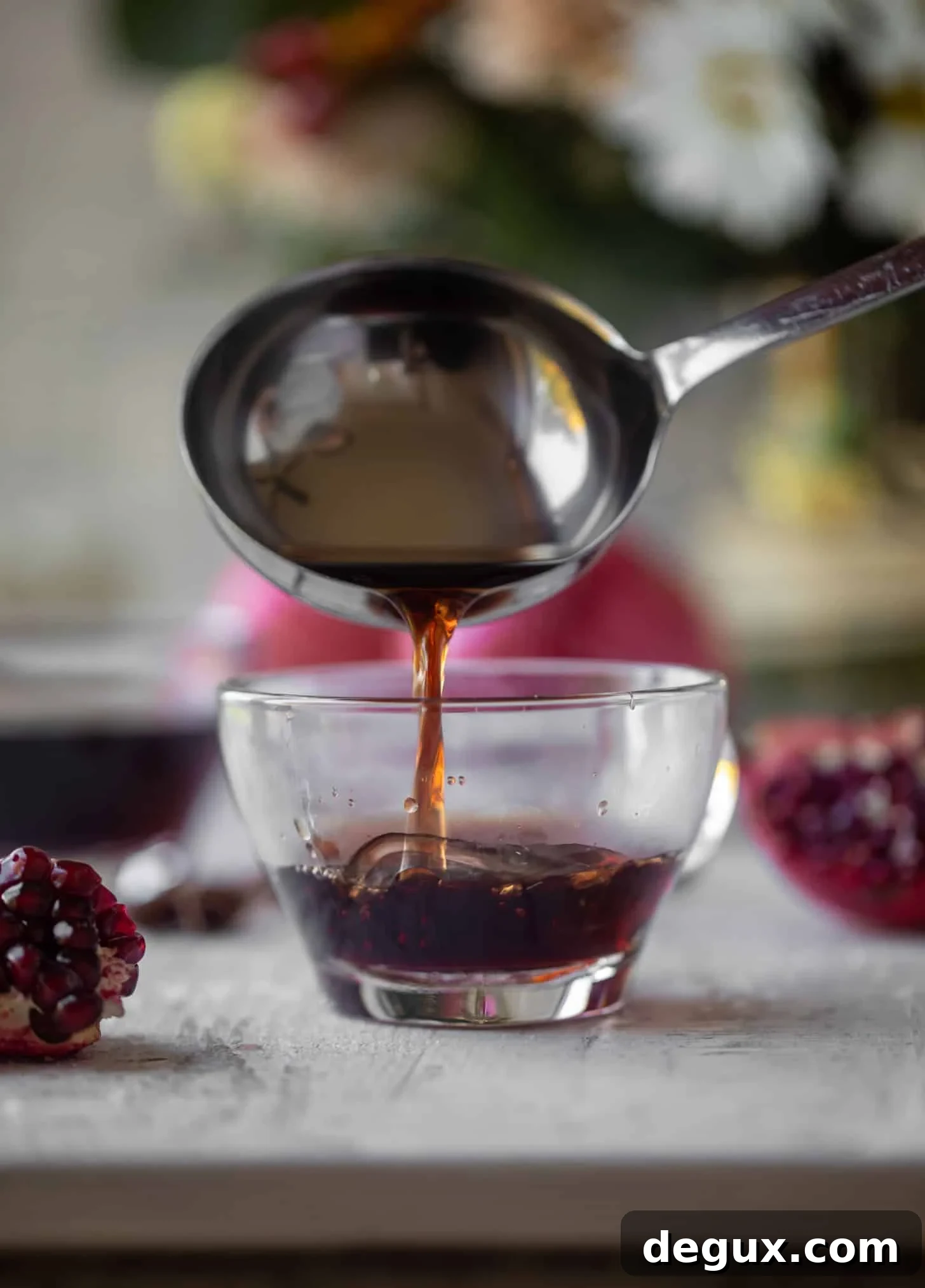 pouring hot pomegranate cider in mug