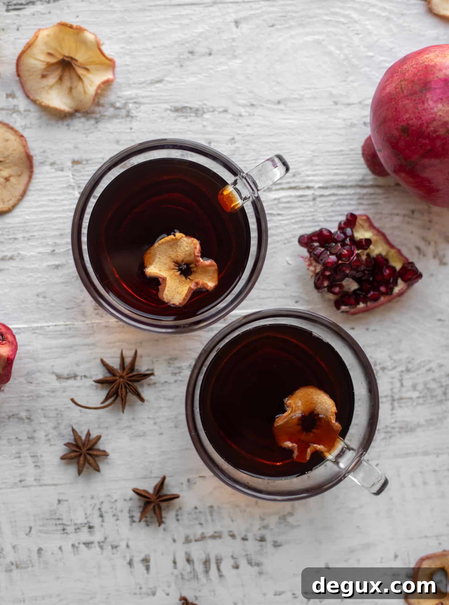 hot pomegranate cider with dried apple slices