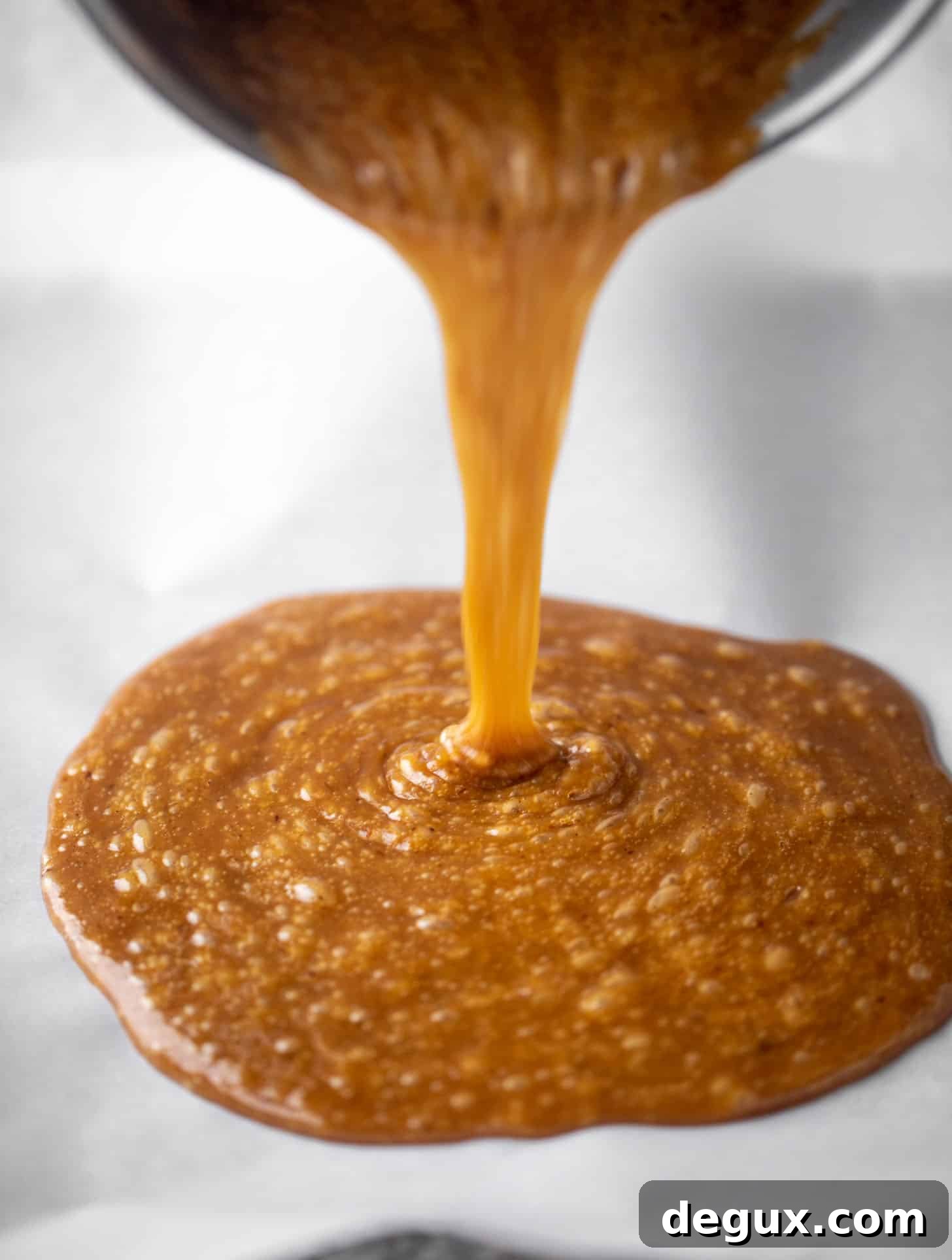 pouring toffee onto pan