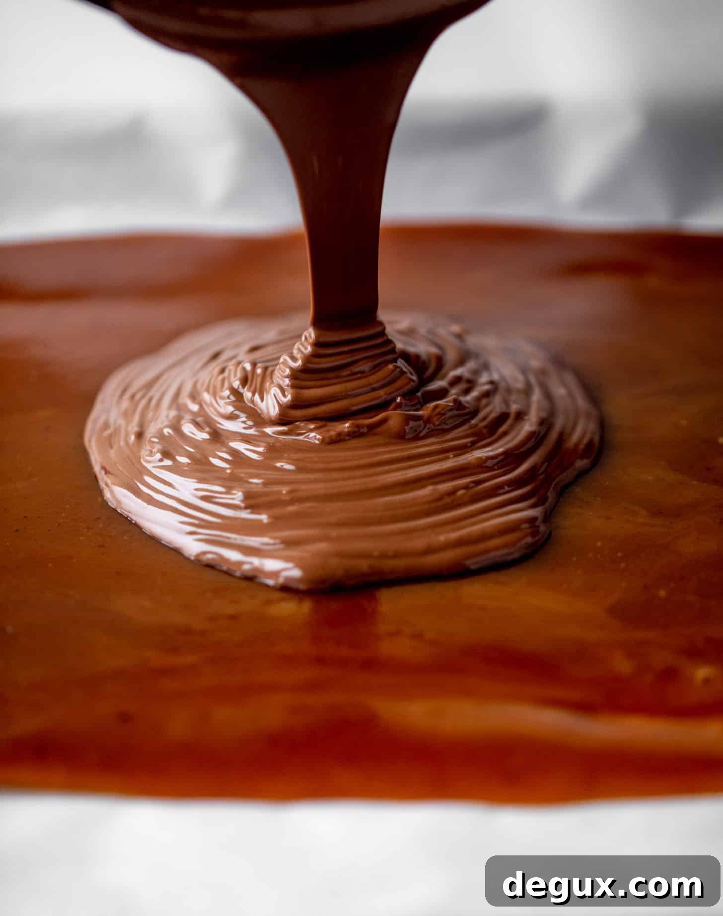 pouring chocolate onto toffee