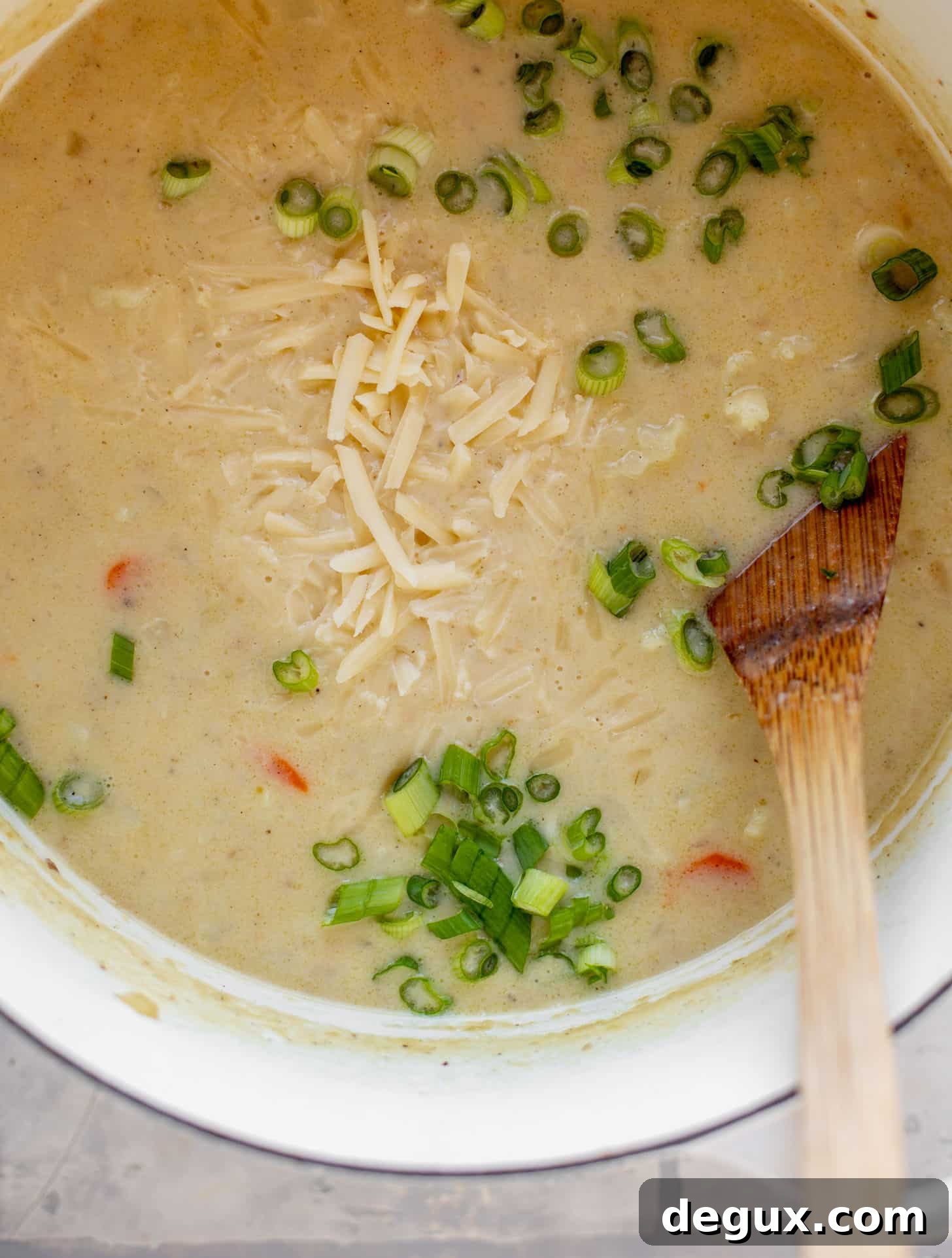 pot of cheddar cauliflower chowder with green onions