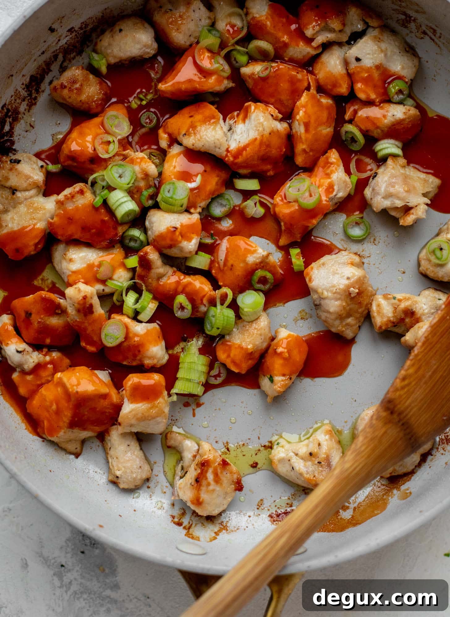 Baked Buffalo Chicken Spaghetti Squash Casserole 4 chicken with wing sauce in a skillet