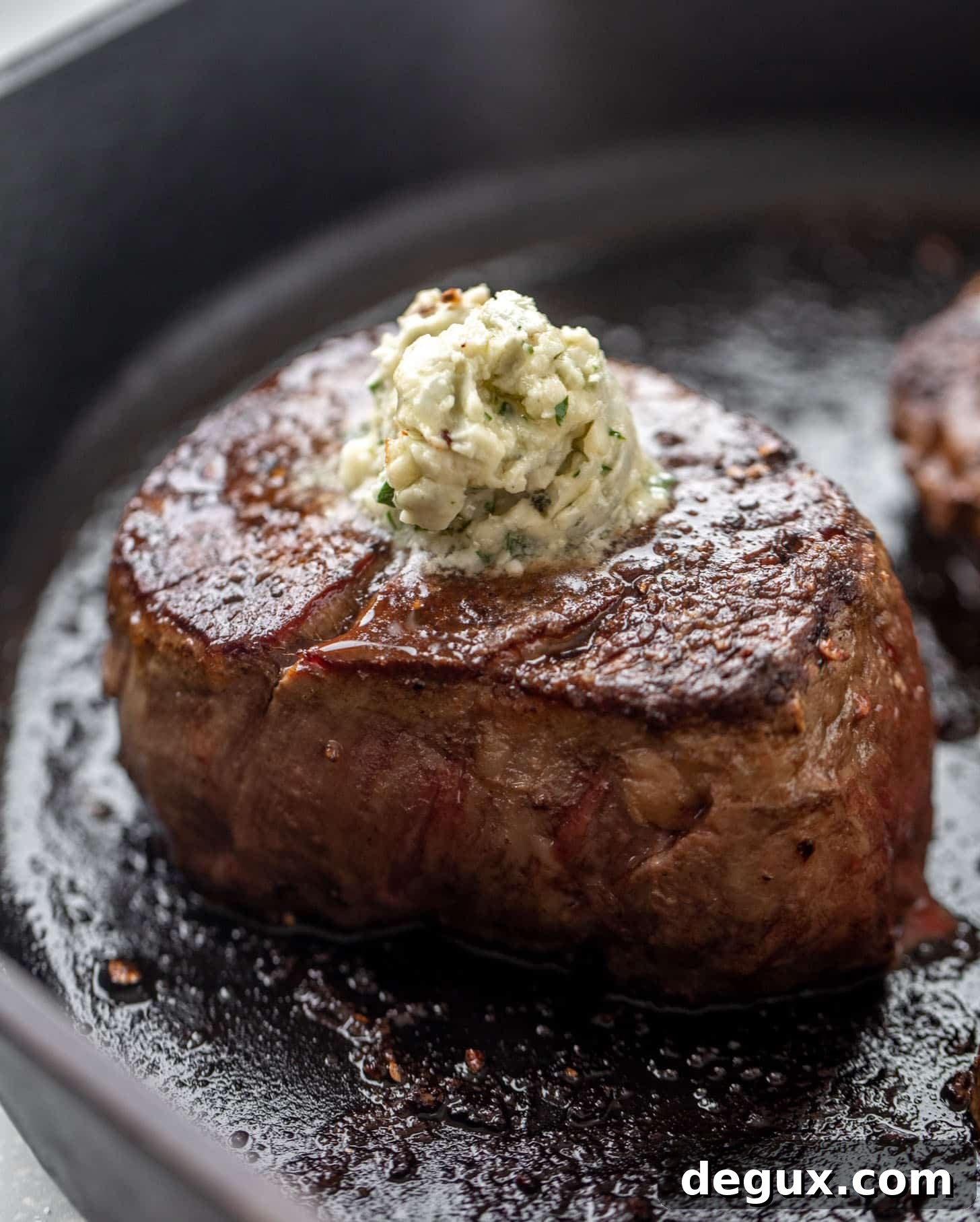 Seared Filet Mignon with Blue Cheese Butter 6 seared steak in a cast iron skillet with blue cheese butter