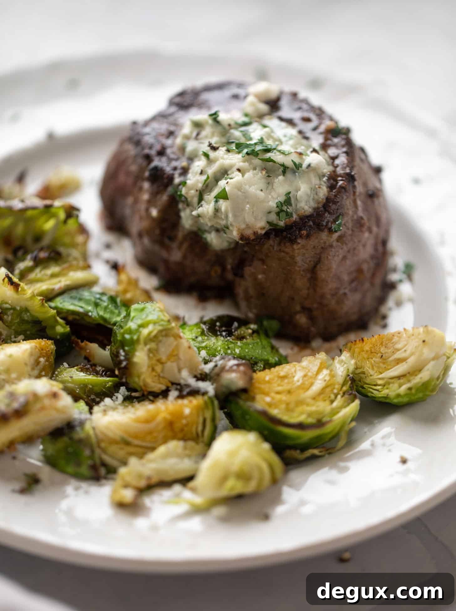 Seared Filet Mignon with Blue Cheese Butter 7 filet mignon with blue cheese butter and cacio e pepe brussels