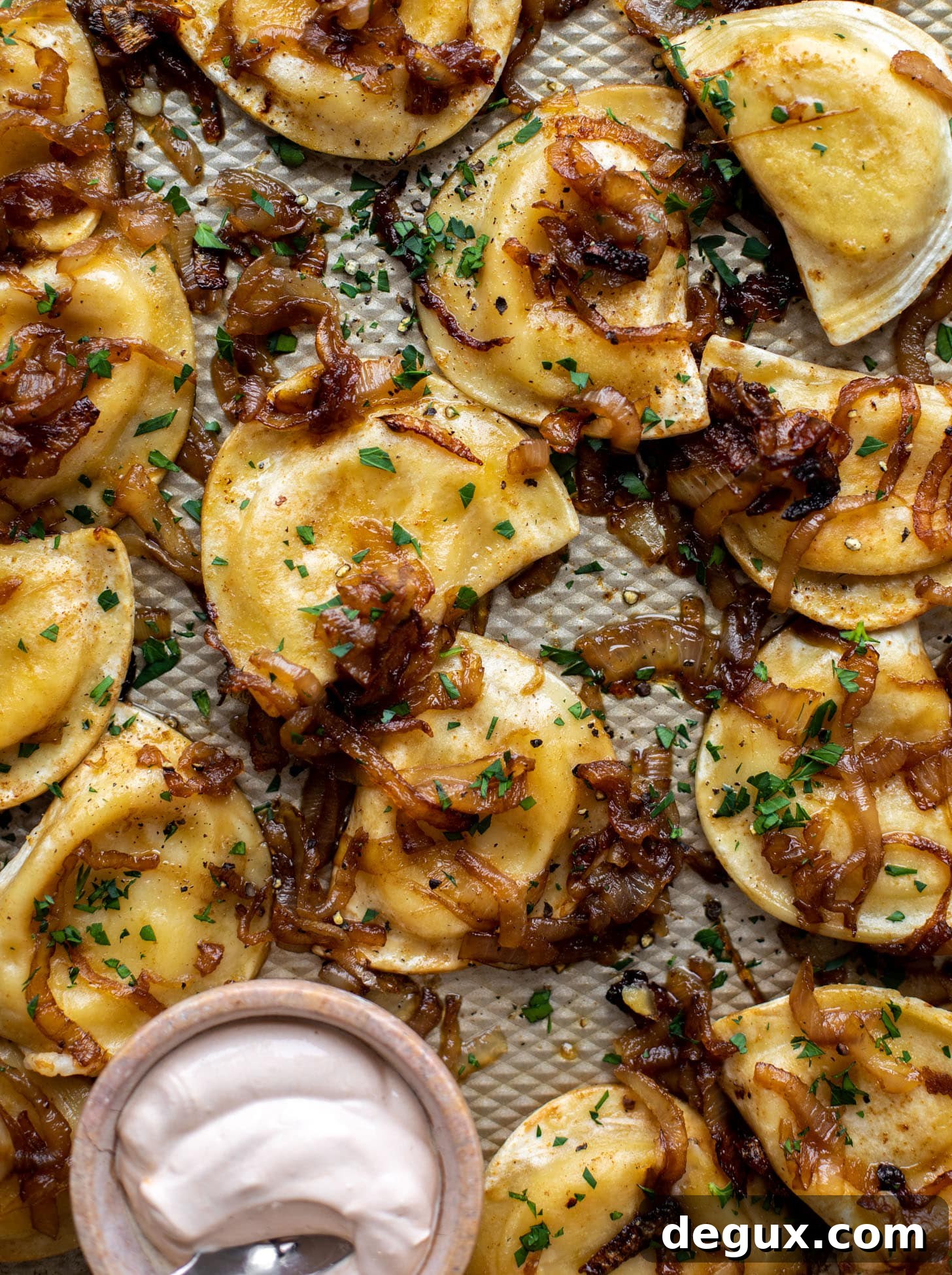sheet pan pierogies with caramelized onions and chipotle sour cream