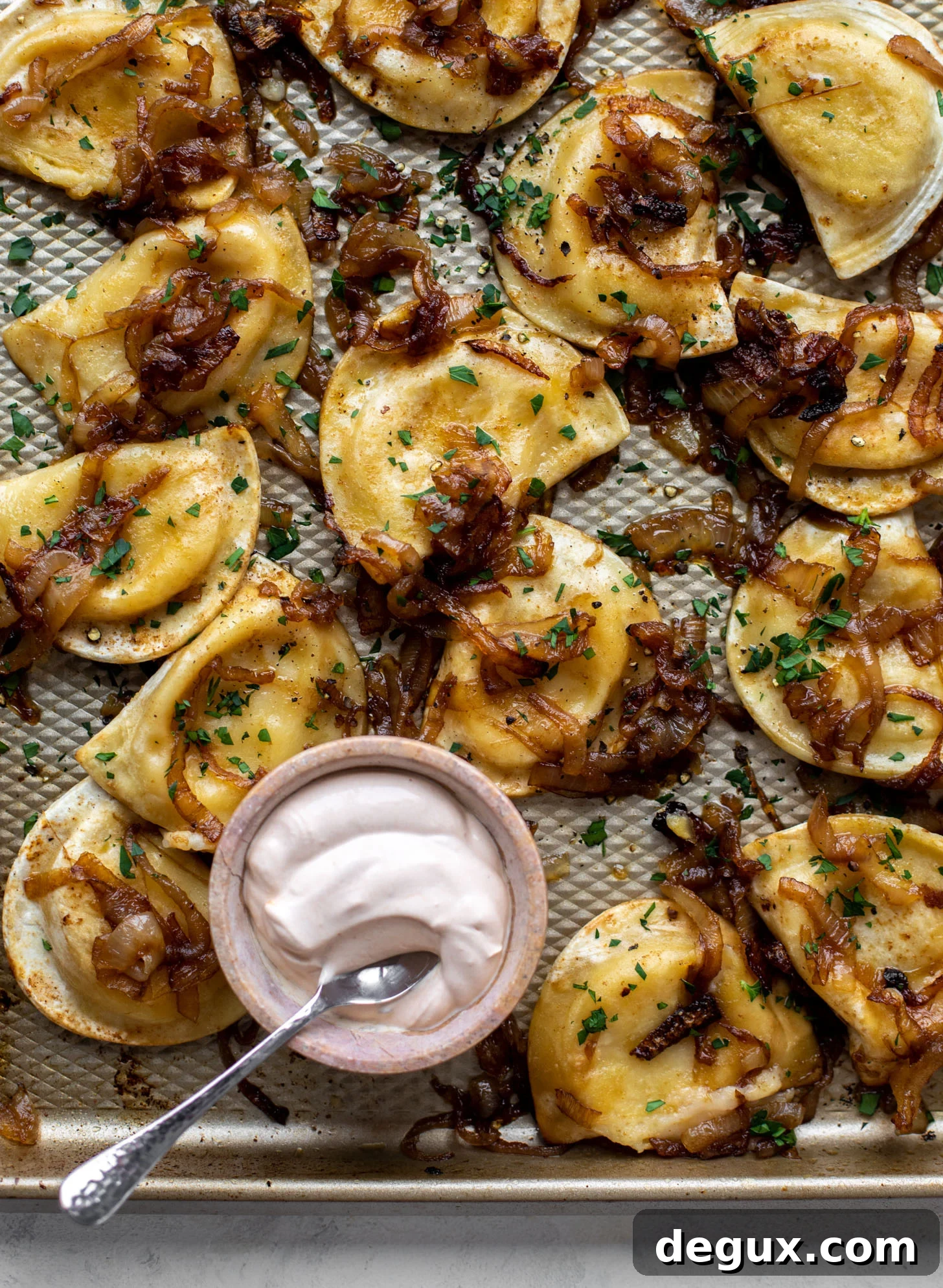 sheet pan pierogies with caramelized onions and chipotle sour cream