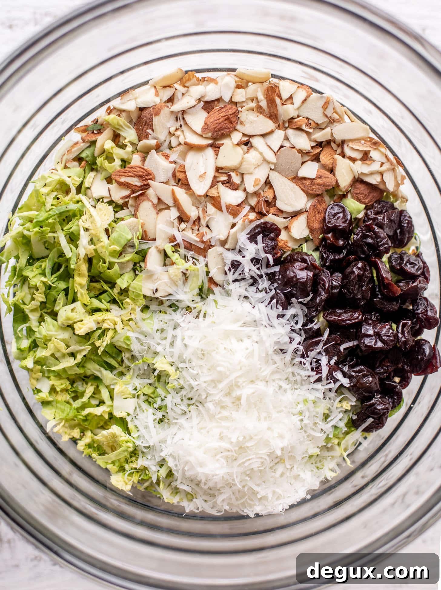 bowl of brussels sprouts, almonds, cheese and cherries