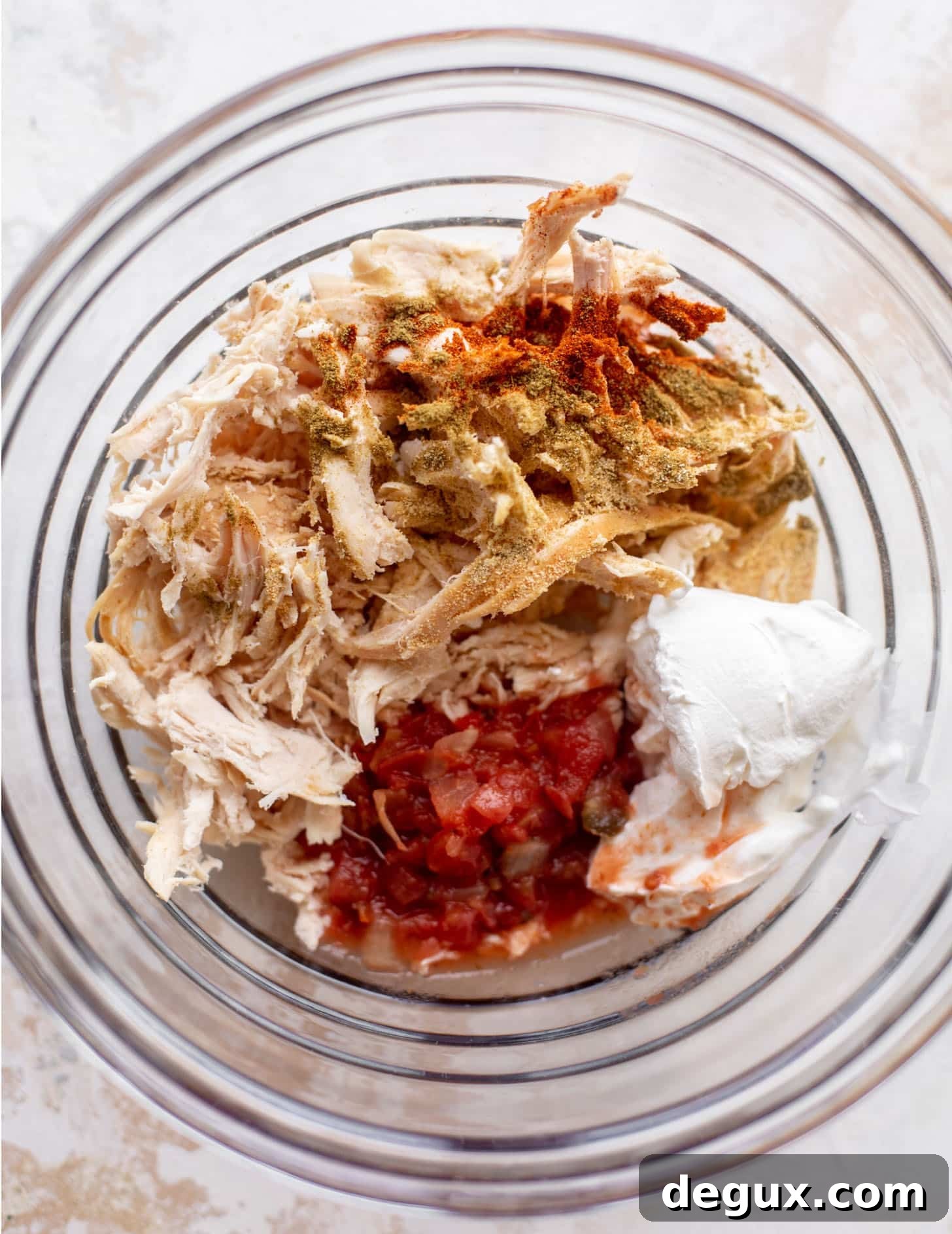 shredded chicken with salsa, spices, sour cream