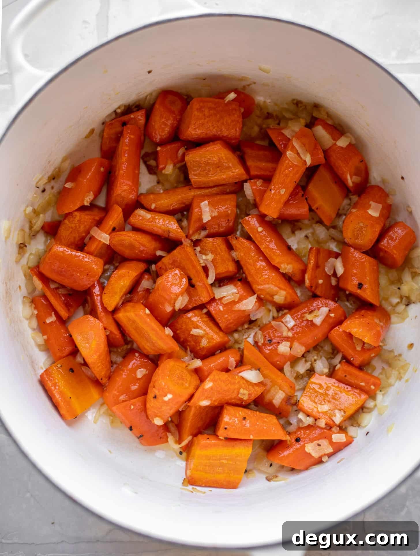 Roasted Carrot and Coconut Soup Recipe for Comforting Flavor 4 roasted carrots in a pot with sautéed onions