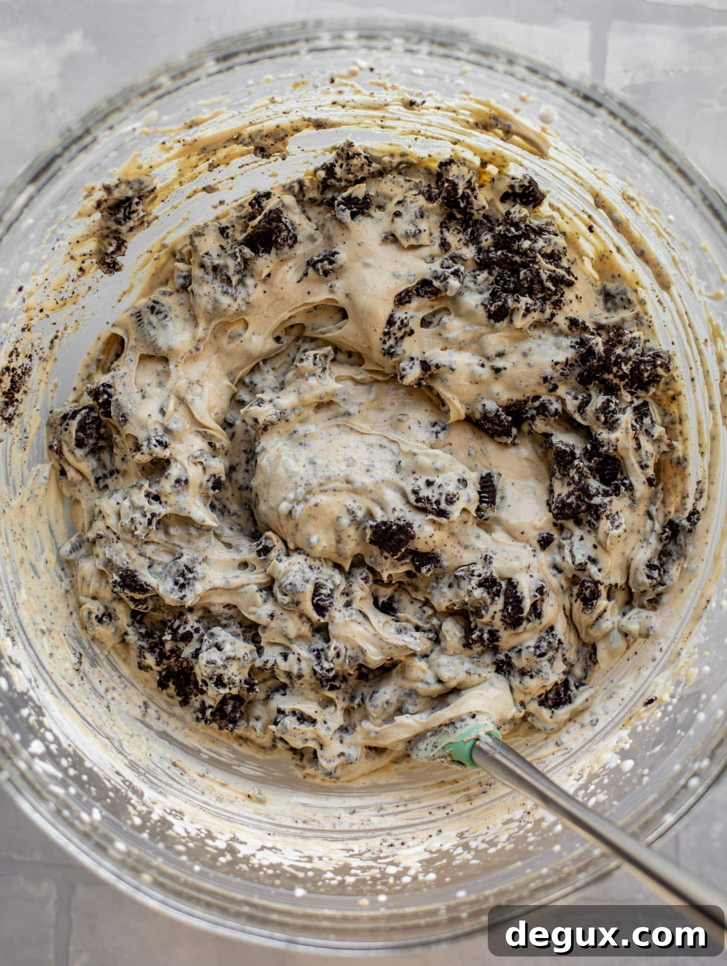 stirring oreos into peanut butter ice cream