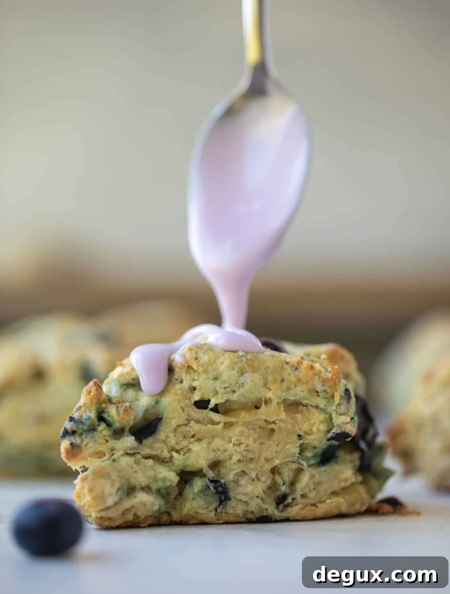 drizzling lavender glaze on blueberry scone