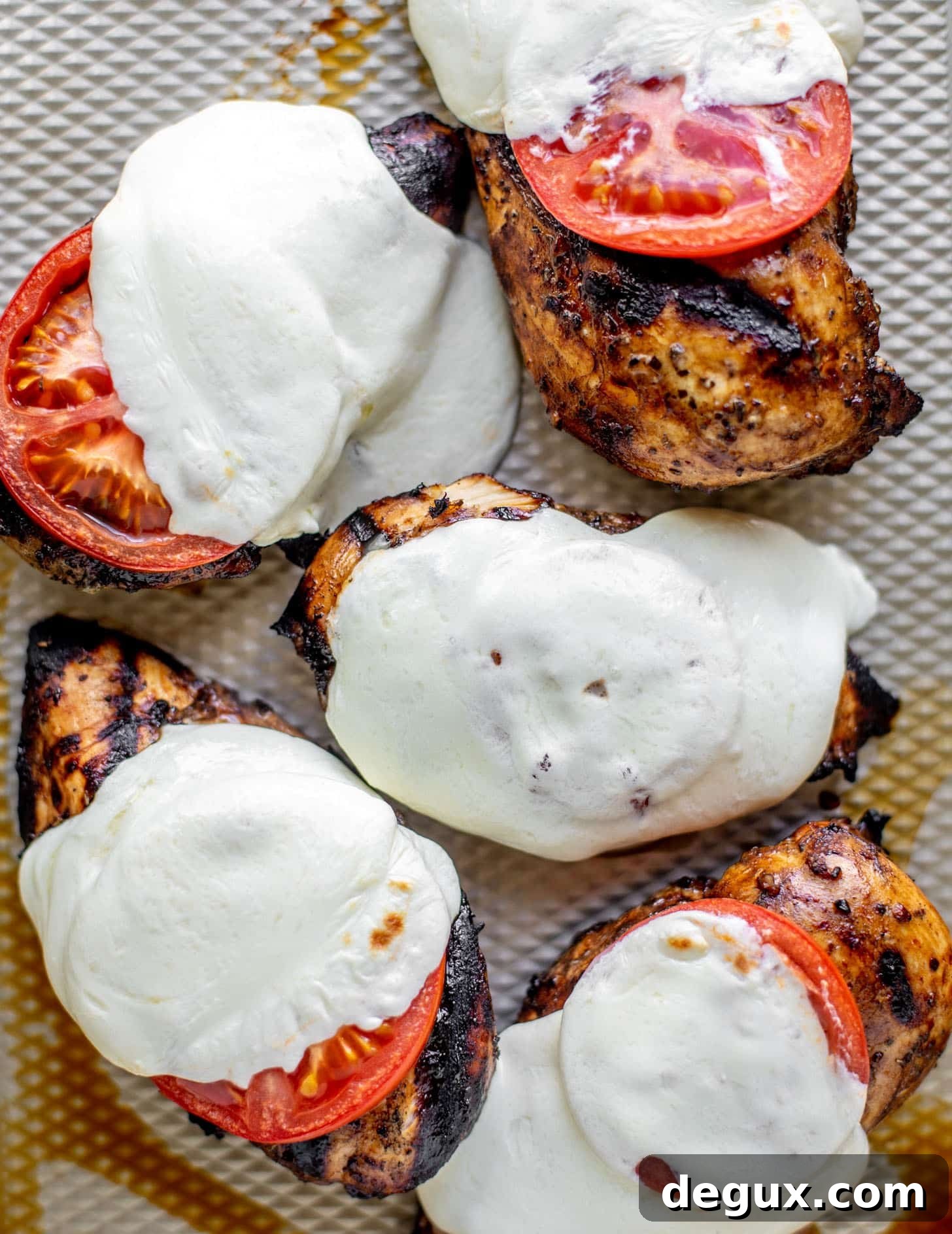 chicken with tomatoes and cheese off the grill