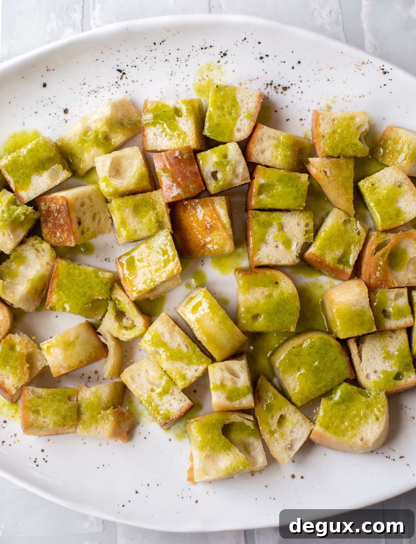 bread cubes drizzled with basil vinaigrette