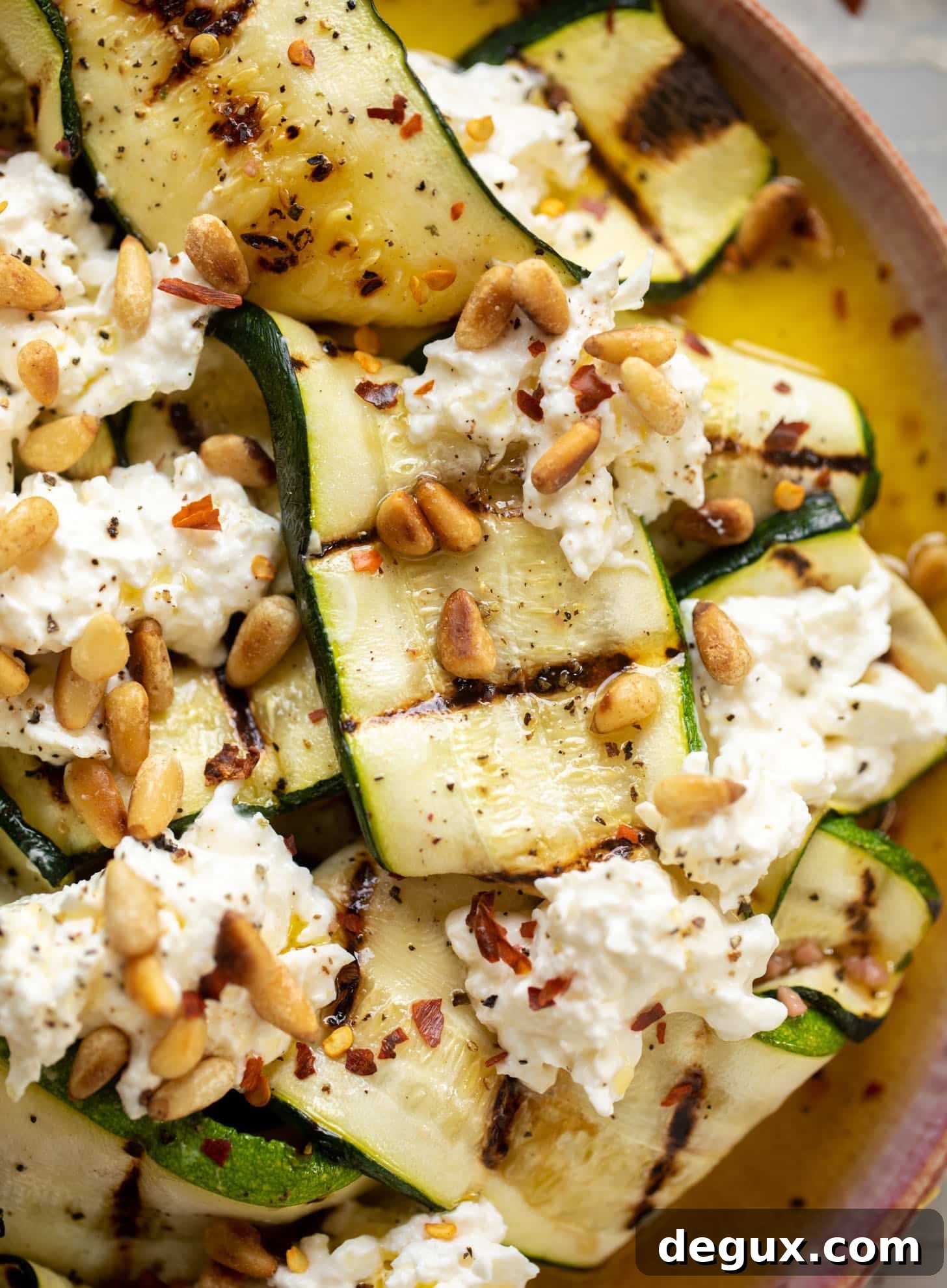 grilled zucchini with burrata and pine nuts