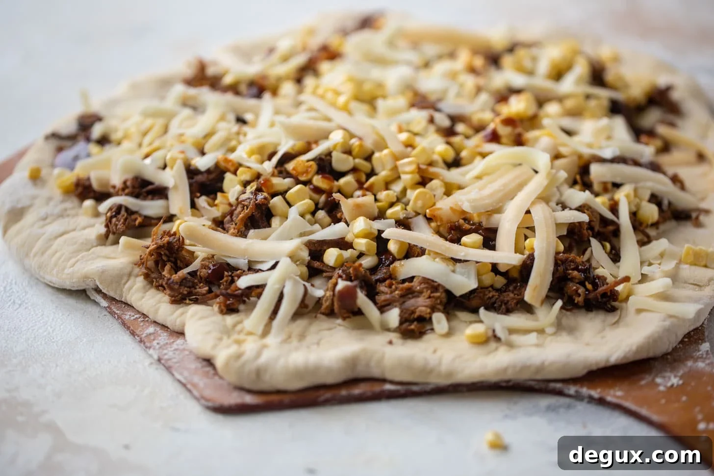 BBQ pulled pork & sweet corn pizza ready for the grill