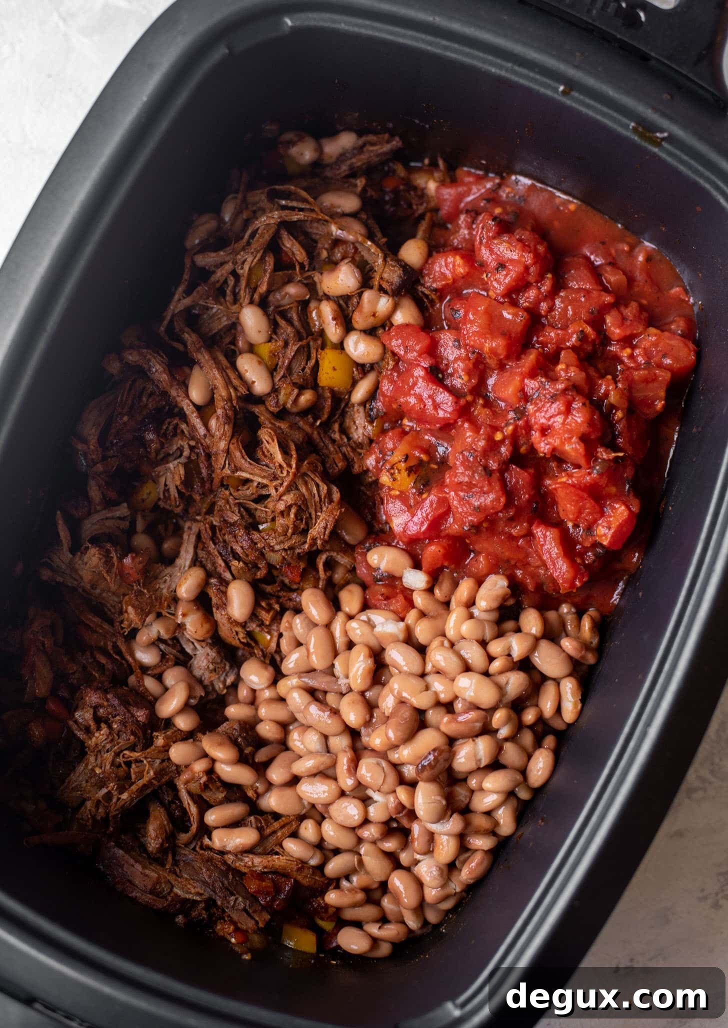 slow cooker with brisket, fire roasted tomatoes and pinto beans