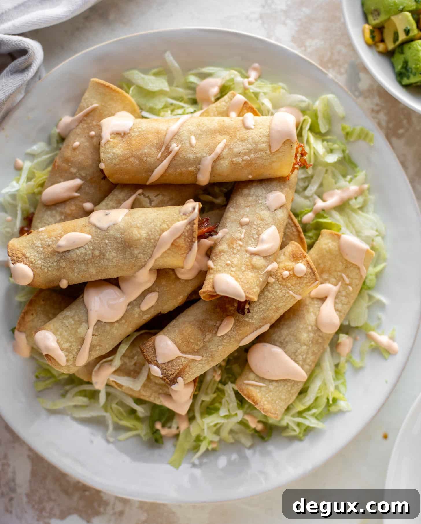 Chipotle Cheddar Pork Taquitos Baked to Crispy Perfection 4 chipotle cheddar baked pork taquitos with crema