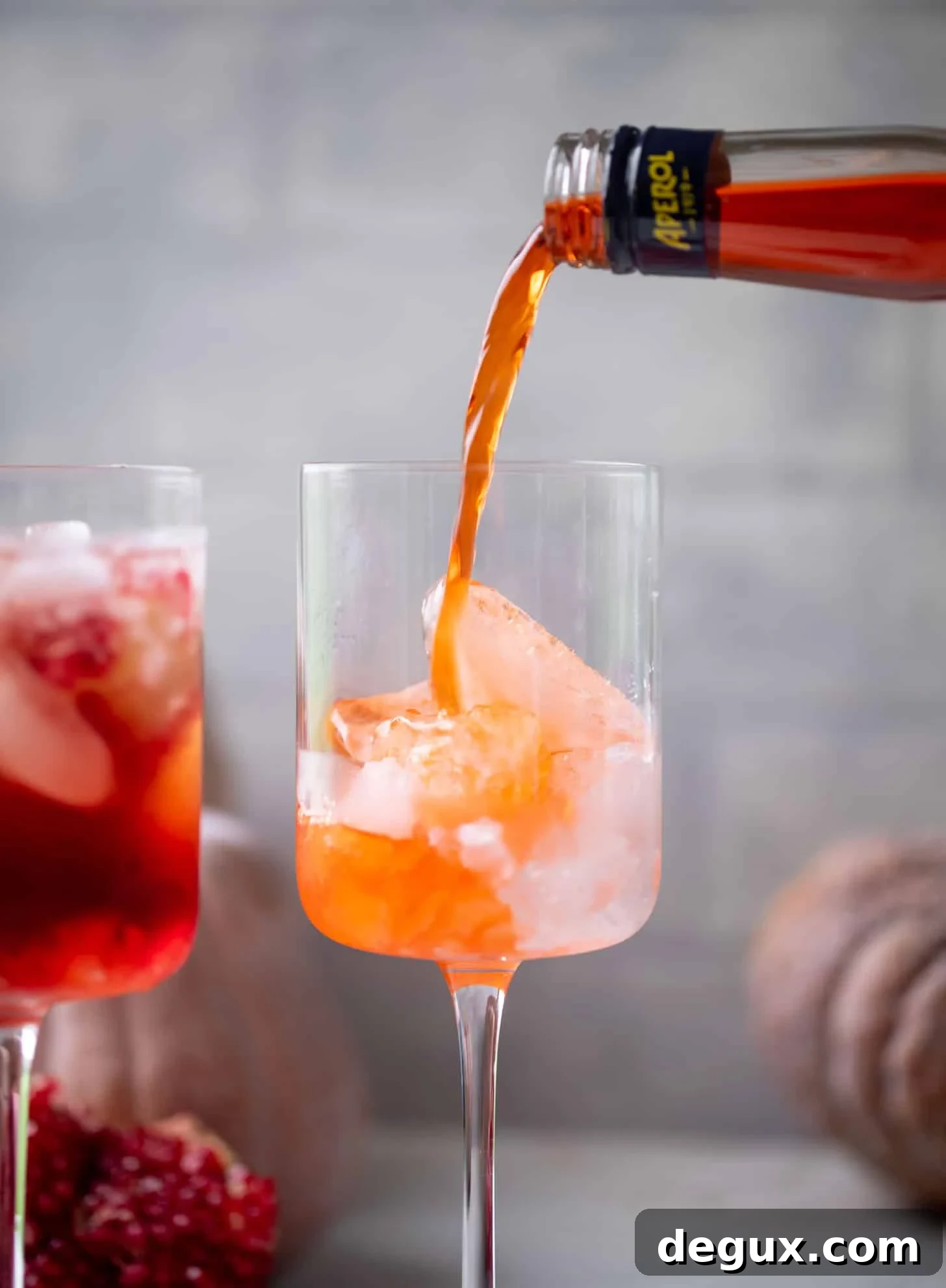 pouring aperol into a glass