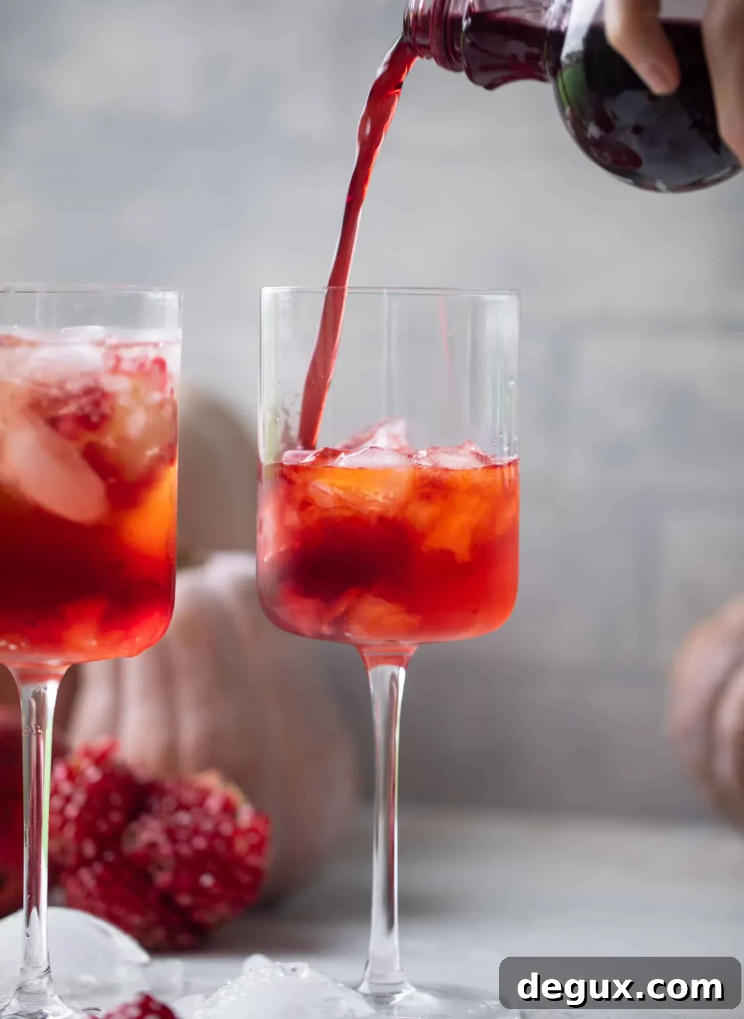 pouring pomegranate juice into a glass