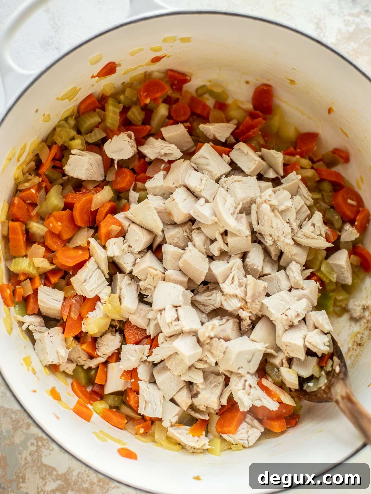 celery, onions, carrots, ginger, garlic and chicken in a pot